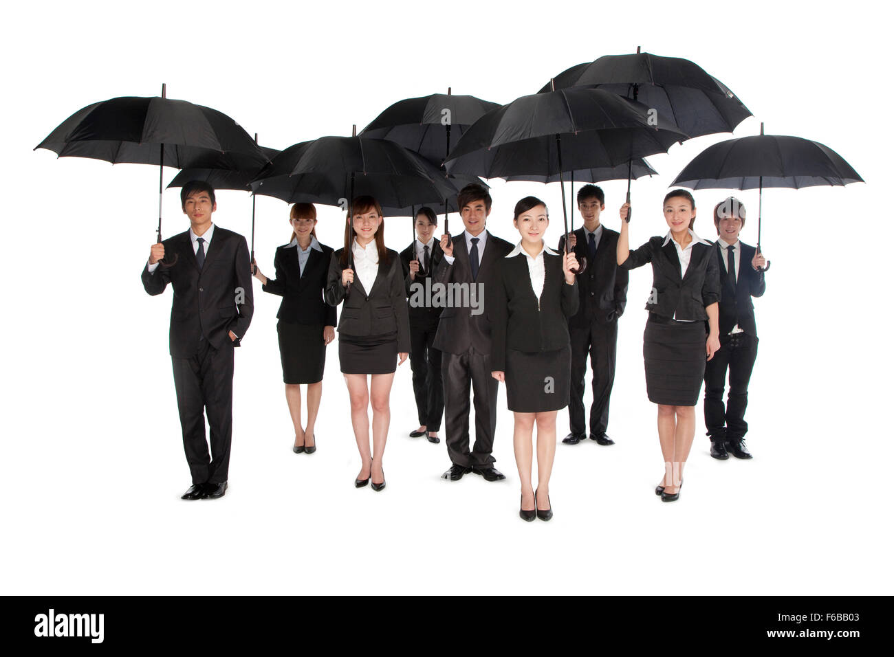 A group of business people holding umbrella Stock Photo