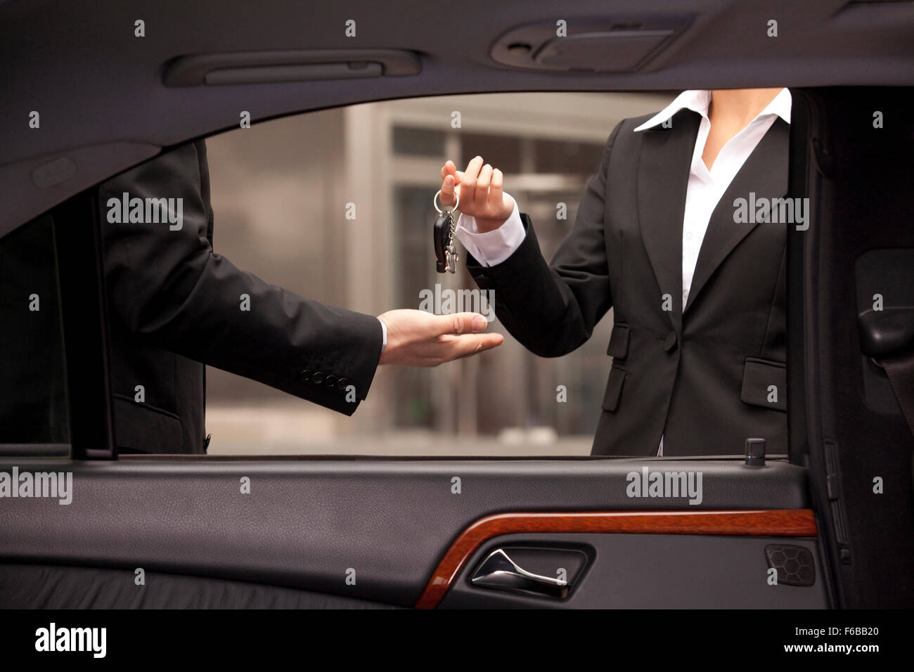 Car dealer giving buyer keys Stock Photo Alamy