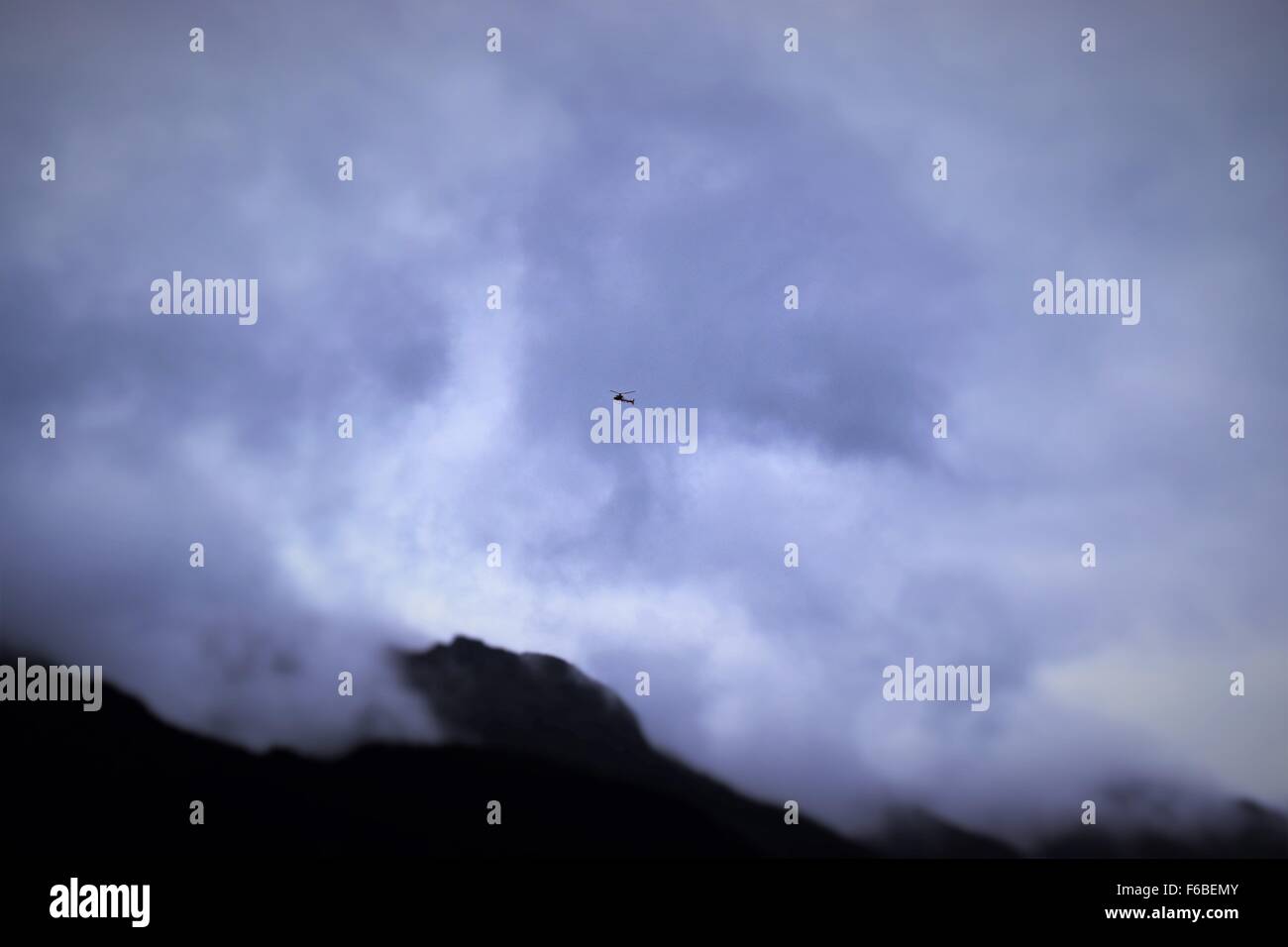 Helicopter in cloudy sky hi-res stock photography and images - Alamy