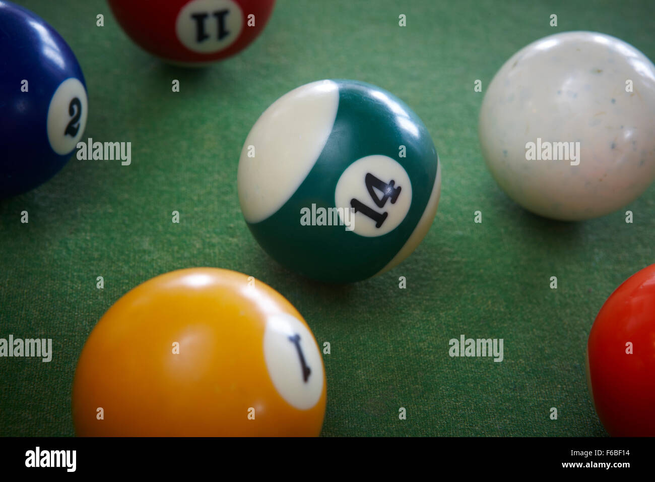 Pool balls close up with focus on the green and white 14 number Stock Photo