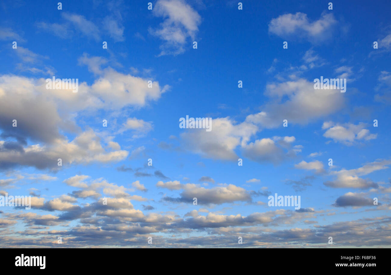 Cumulus clouds against a clear blue sky. Stock Photo