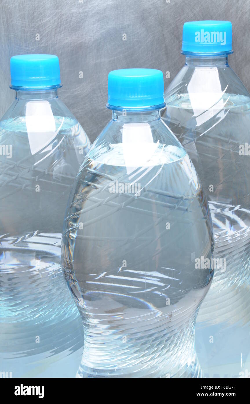 https://c8.alamy.com/comp/F6BG7F/plastic-bottles-of-water-on-gray-metal-background-F6BG7F.jpg