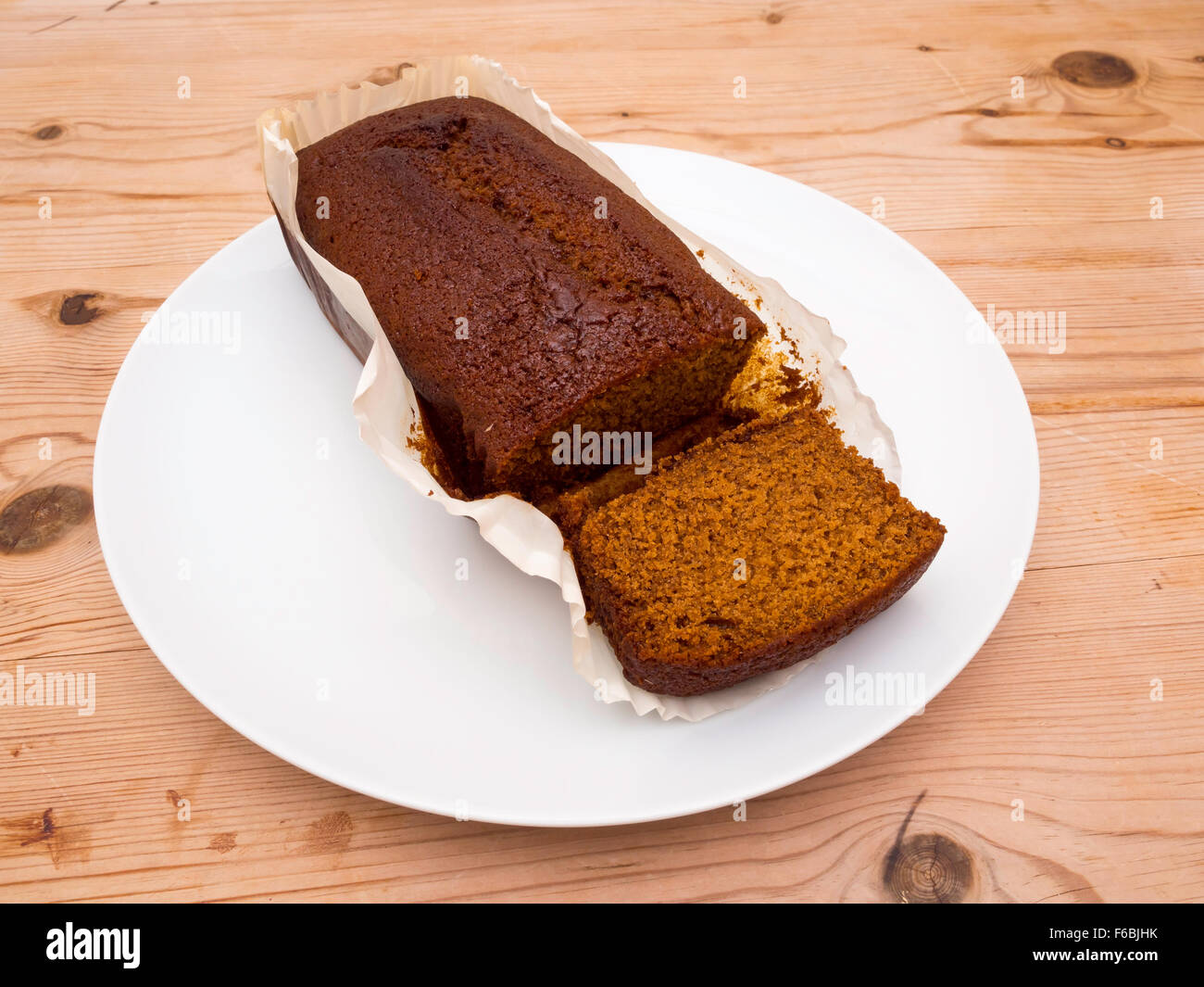 Yorkshire Parkin or Perkin a traditional cake made with treacle oatmeal and ginger white plate