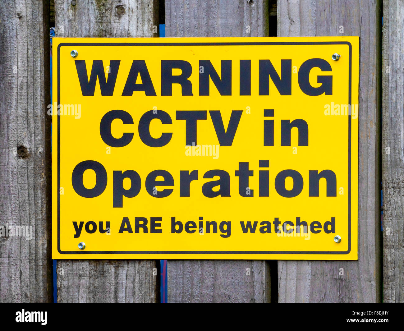 Notice warning of the presence of CCTV surveillance cameras Warning CCTV in operation you are being watched Stock Photo
