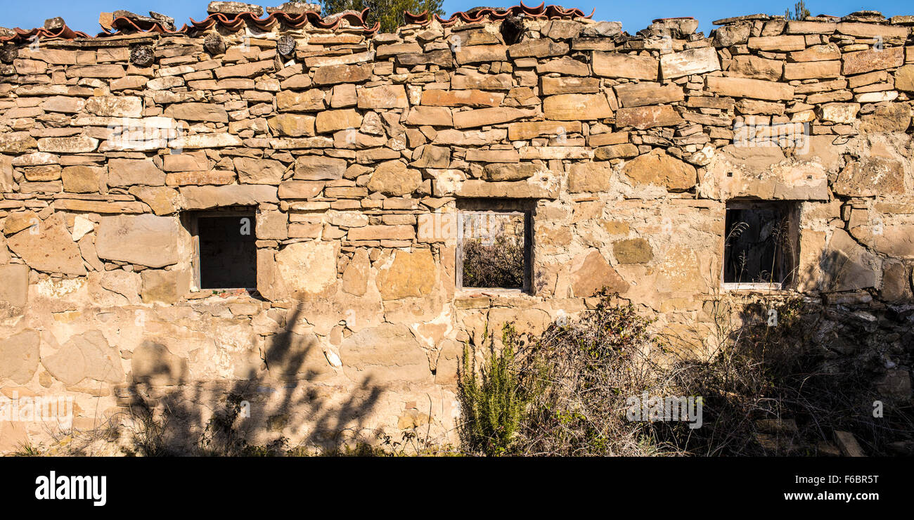 A stone wall of an old house in ruins Stock Photo - Alamy