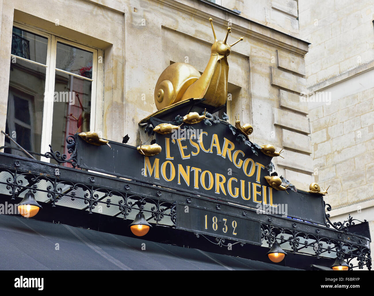 Restaurant L'Escargot sign, with golden snail, Rue Montorgueil, Paris, Ile de France, France Stock Photo