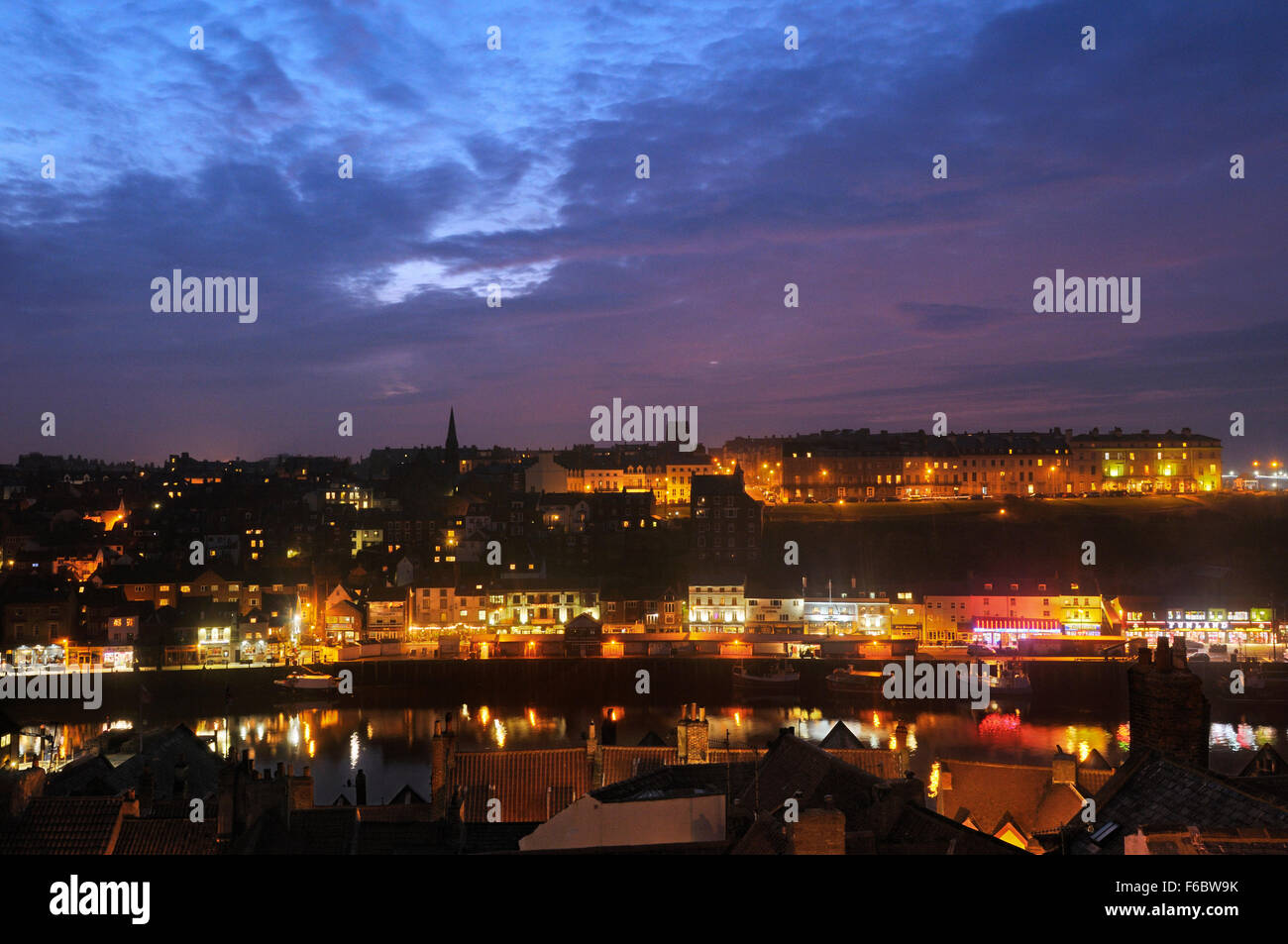 Whitby town and harbour at dusk, North Yorkshire, England, UK Stock Photo