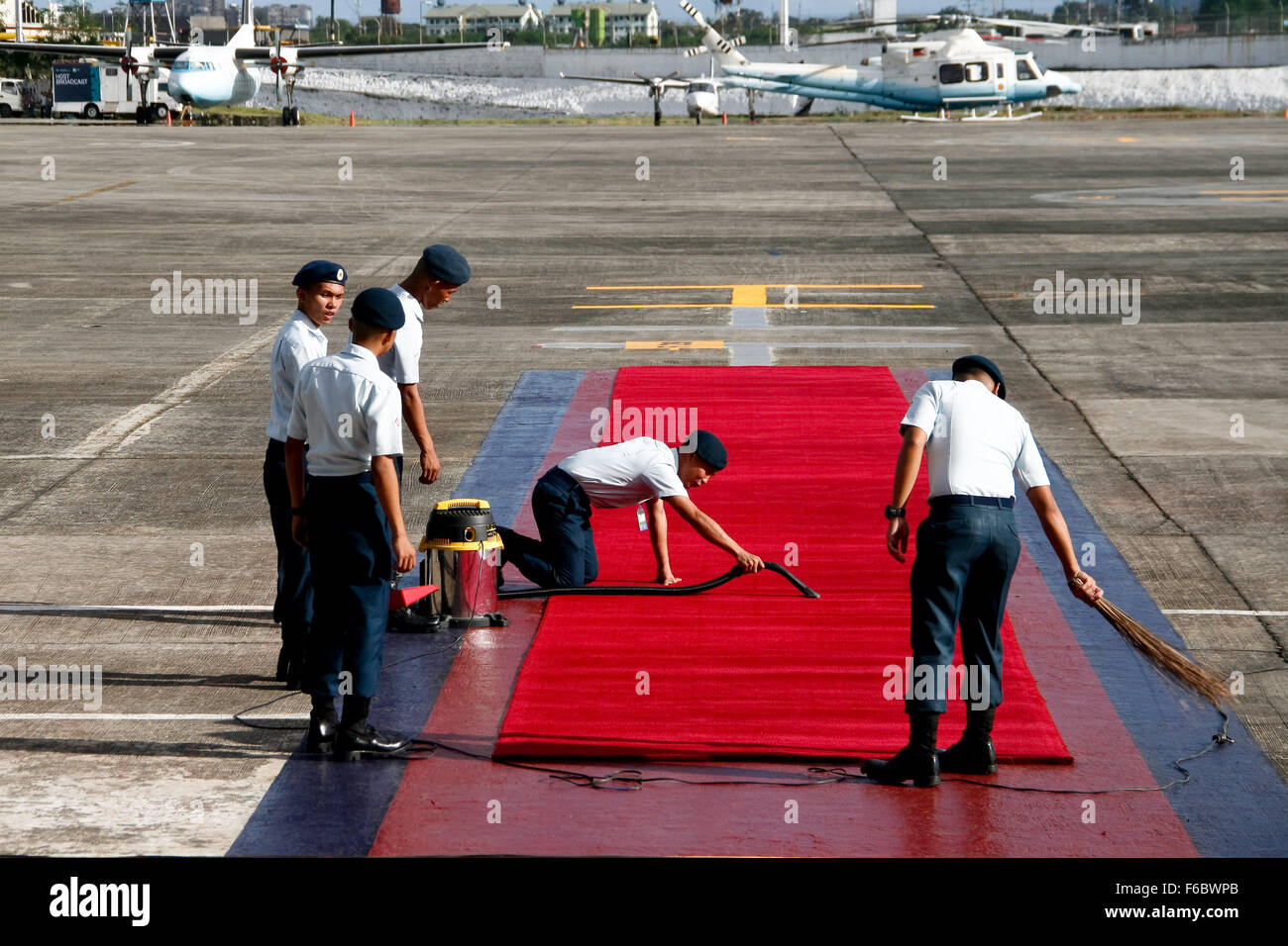 Members of the Philippine Air Force cleaning the red carpet in