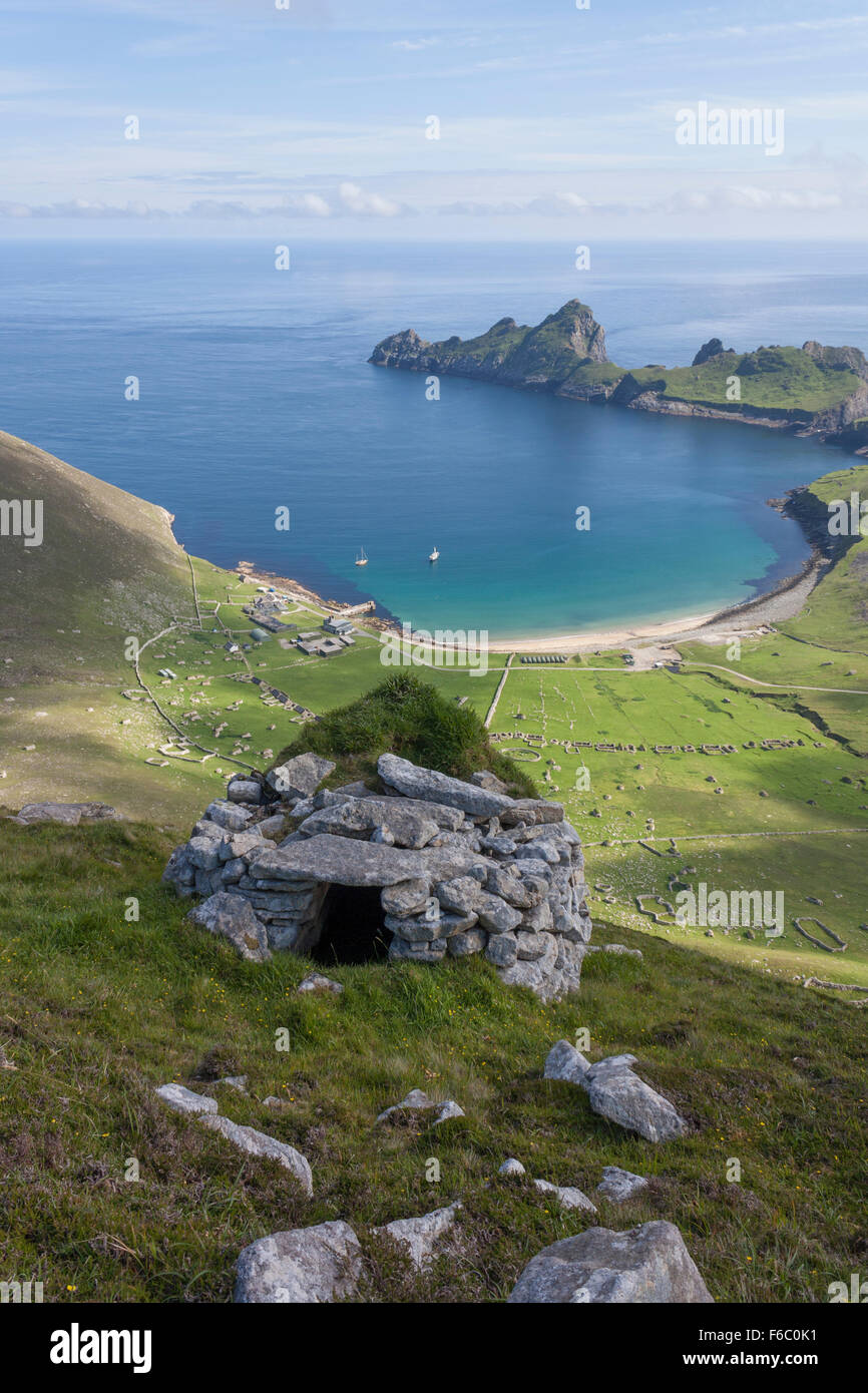Hillside view of Village Bay, St Kilda, Scotland, with an ancient drystone structure called 'cleit' in the foreground. Stock Photo
