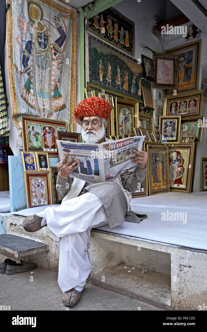 Shop owner reading newspaper, Shrinathji Temple, Nathdwara, Rajasthan