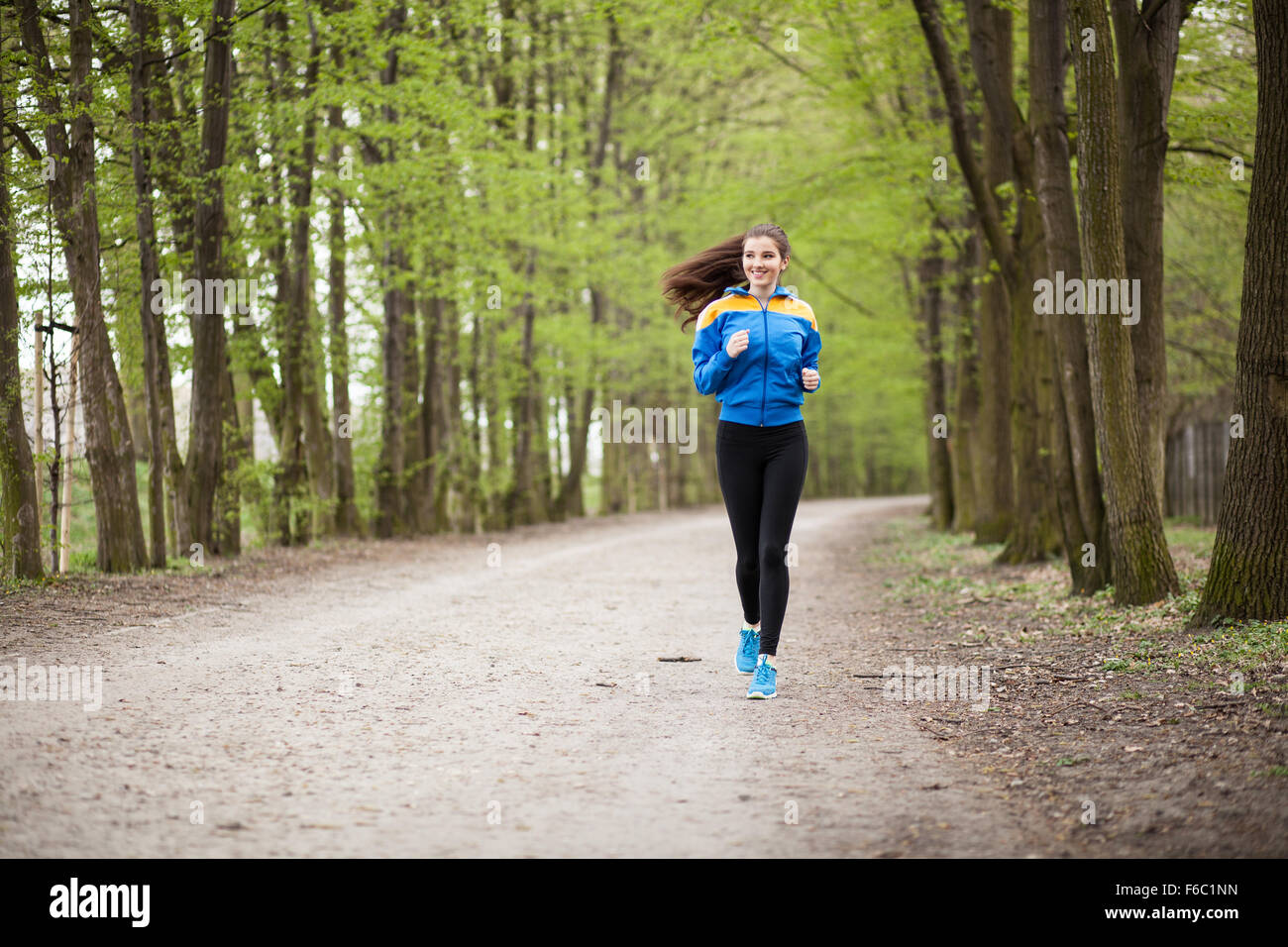 Young beautiful woman running on a trail Stock Photo - Alamy