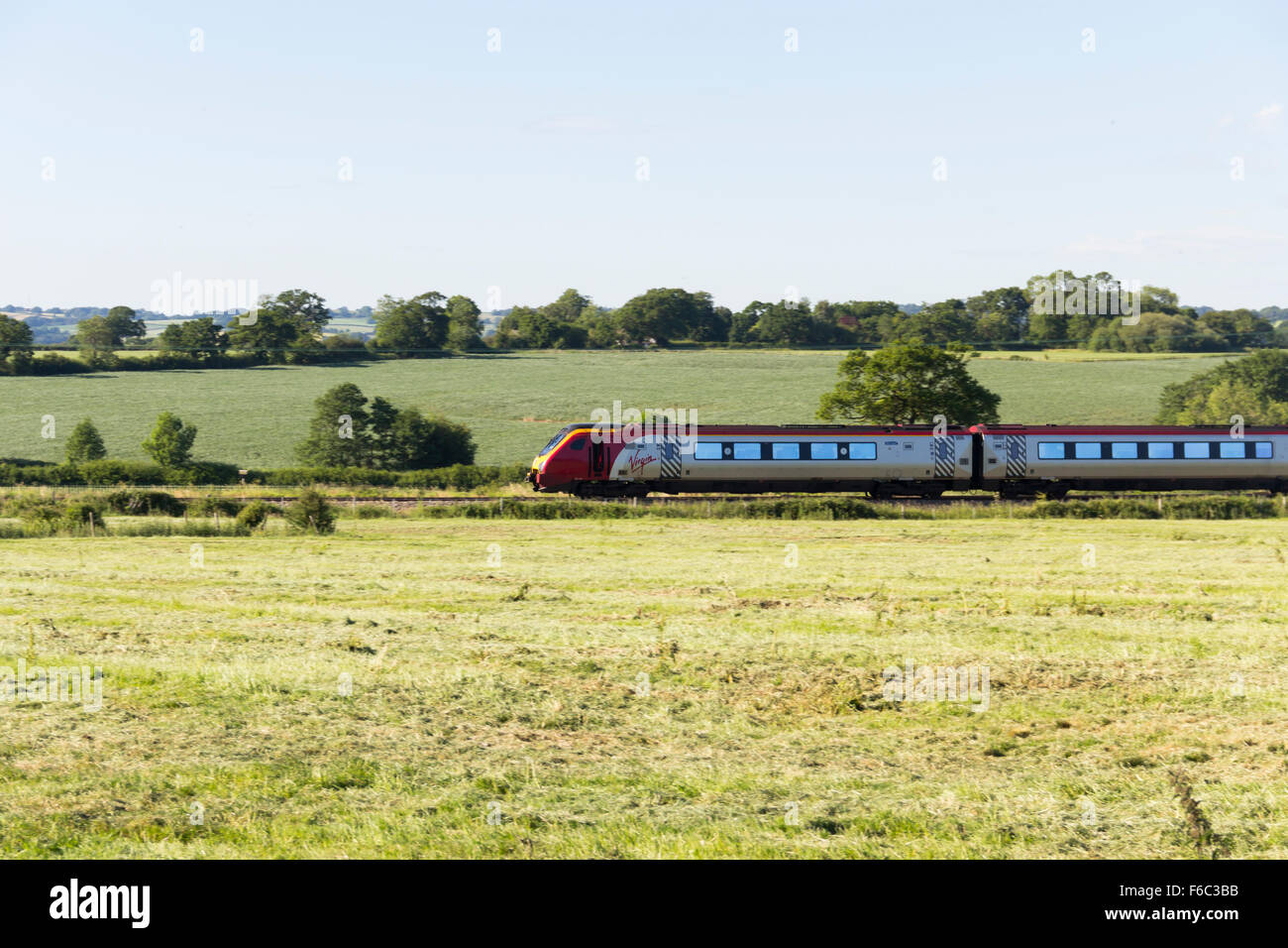 A class 221 Virgin Voyager four coach express train passes though open countryside near Beeston, Cheshire heading west Stock Photo