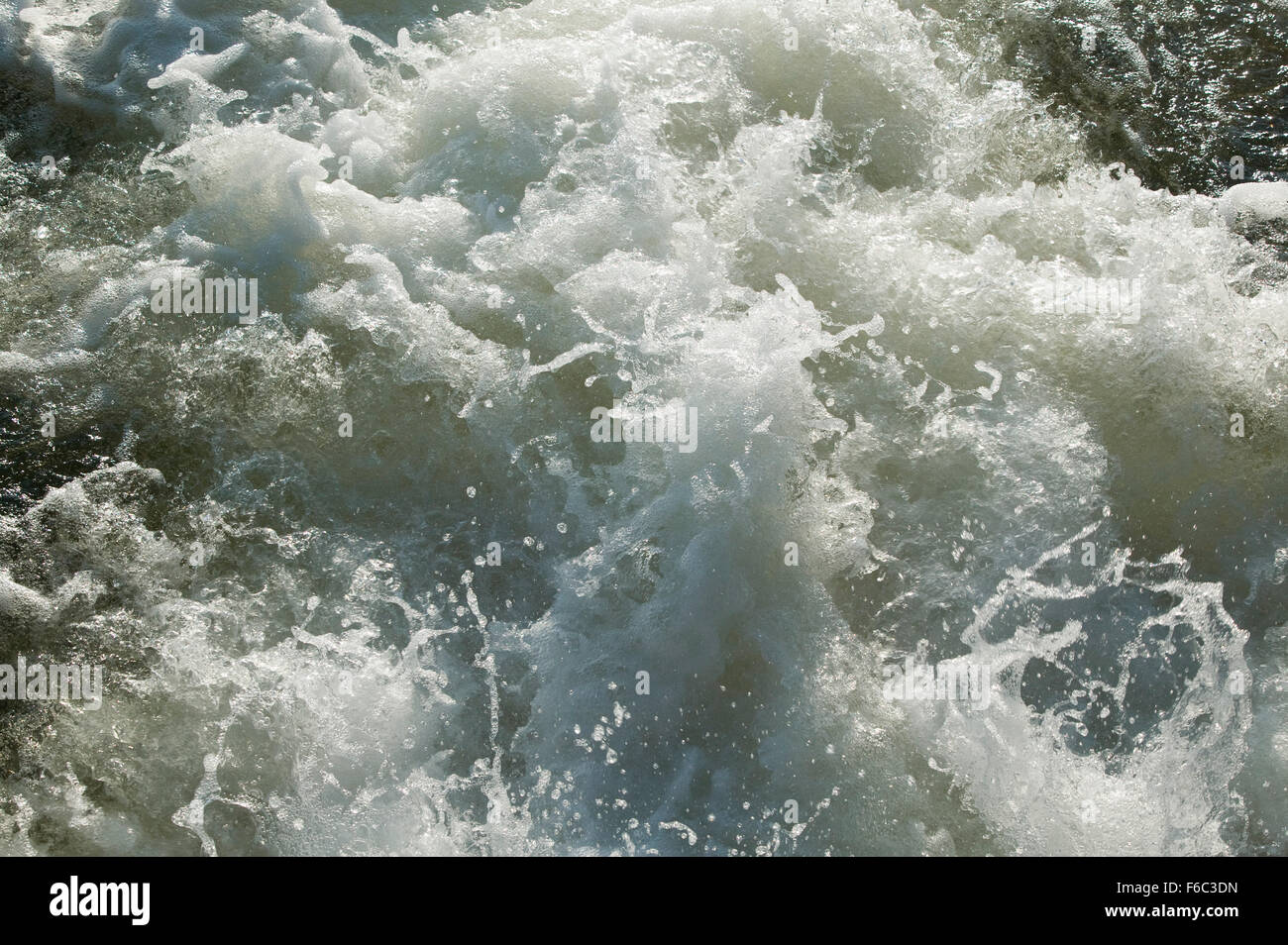 Water churning and bubbling with energy as it falls from a lock and