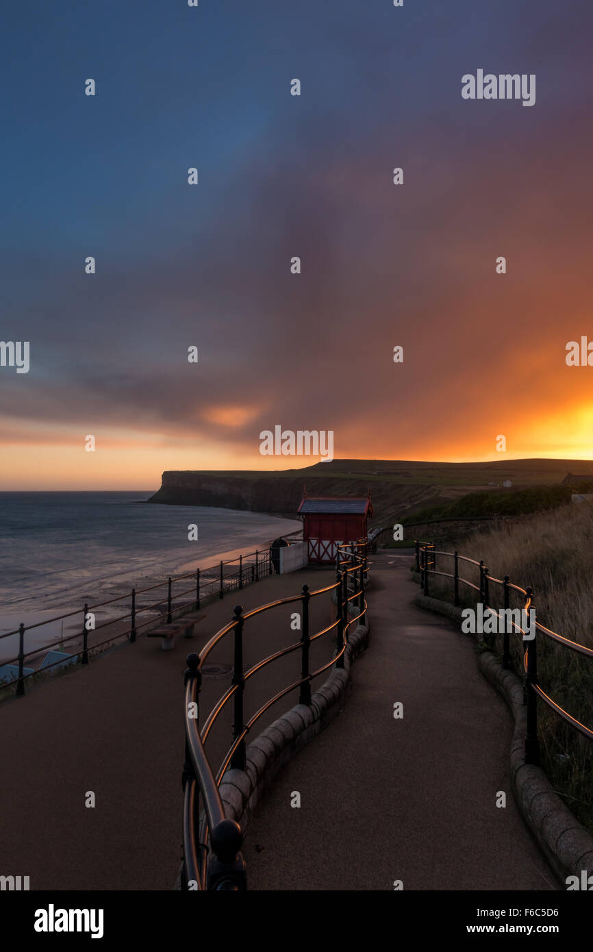 Enjoying the sunrise and reflections over the North Sea at Saltburn-by-the-Sea, Cleveland, North Yorkshire, England Stock Photo