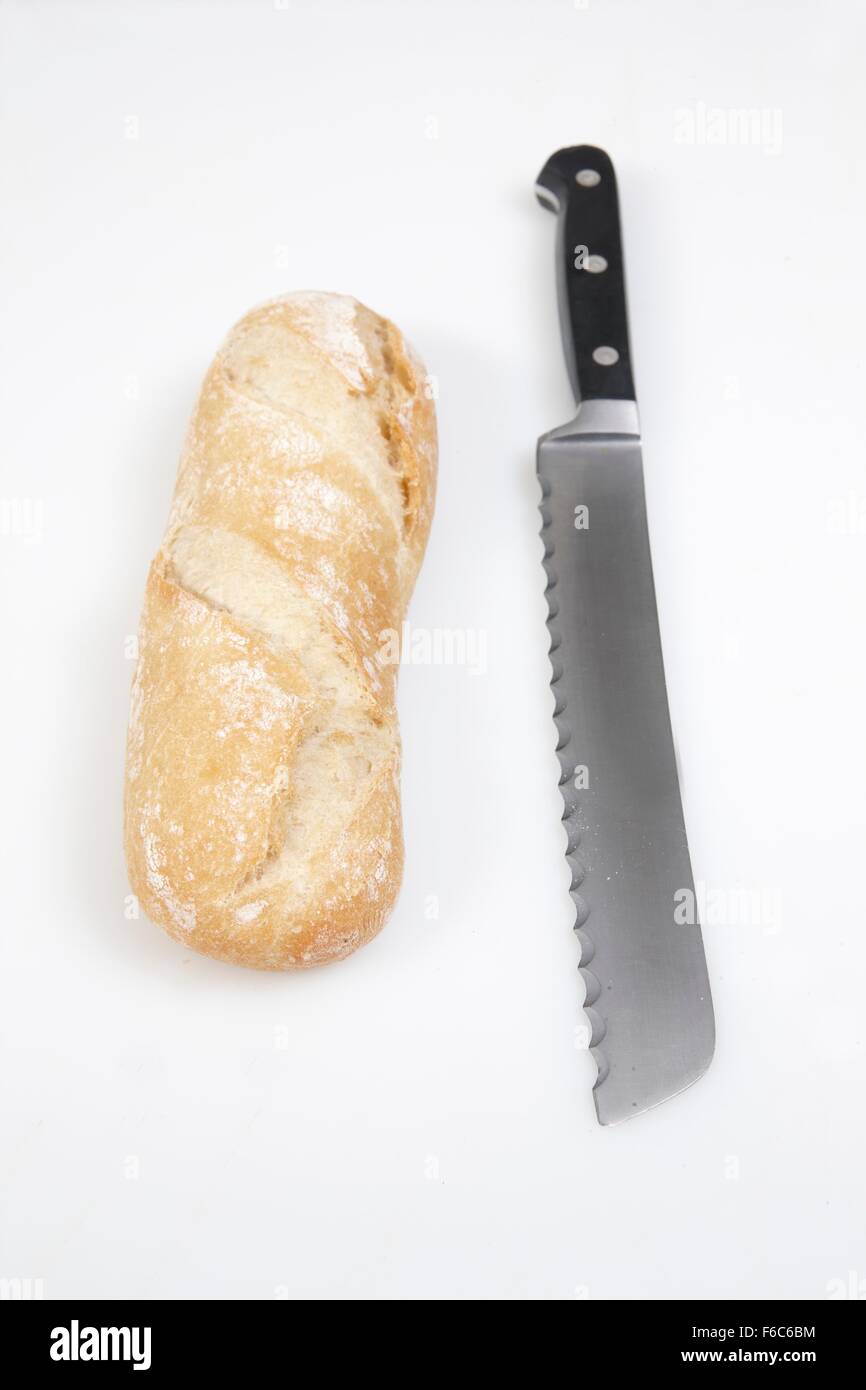 A white baguette and a bread knife Stock Photo