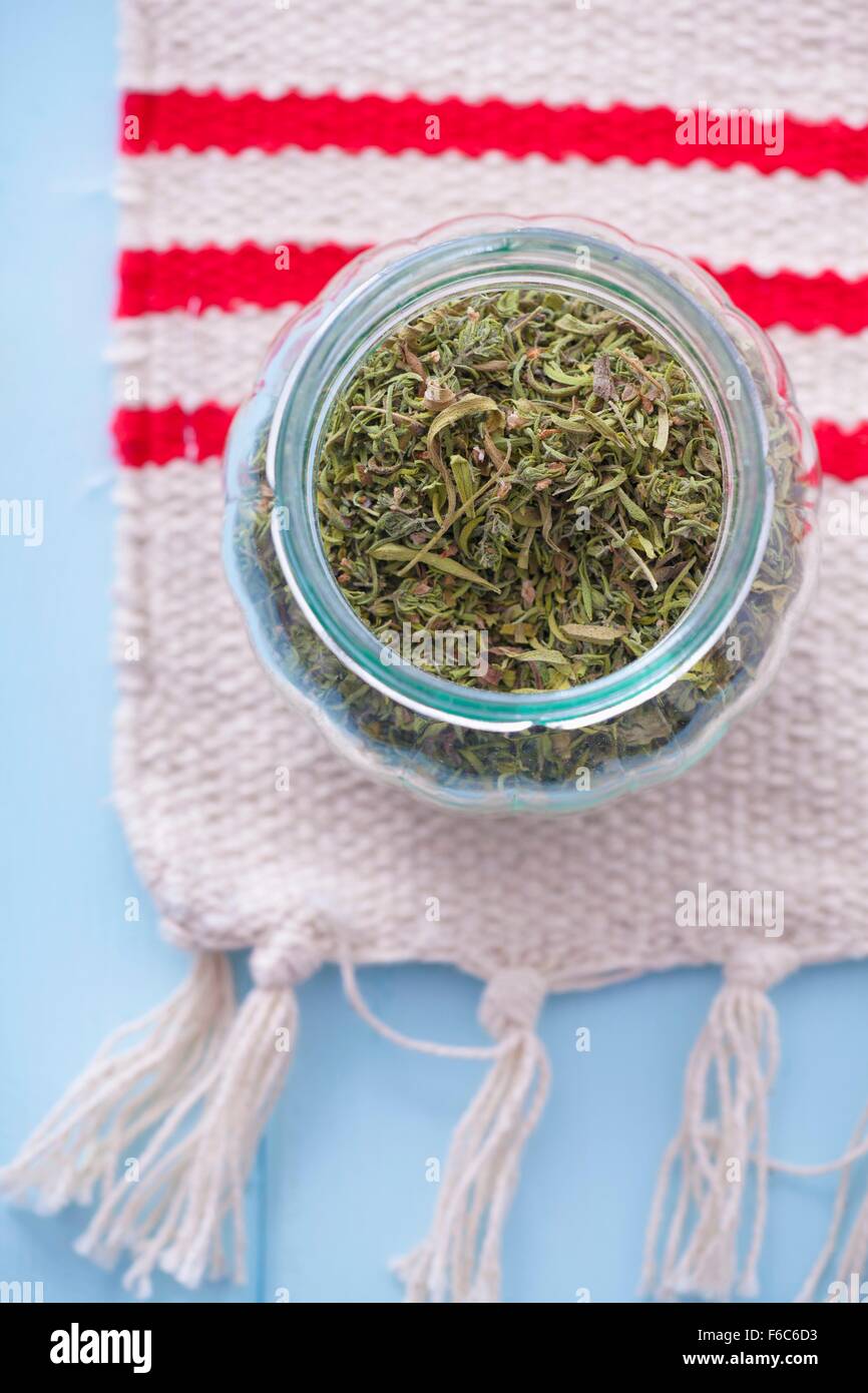 Jar of dried summer savory Stock Photo