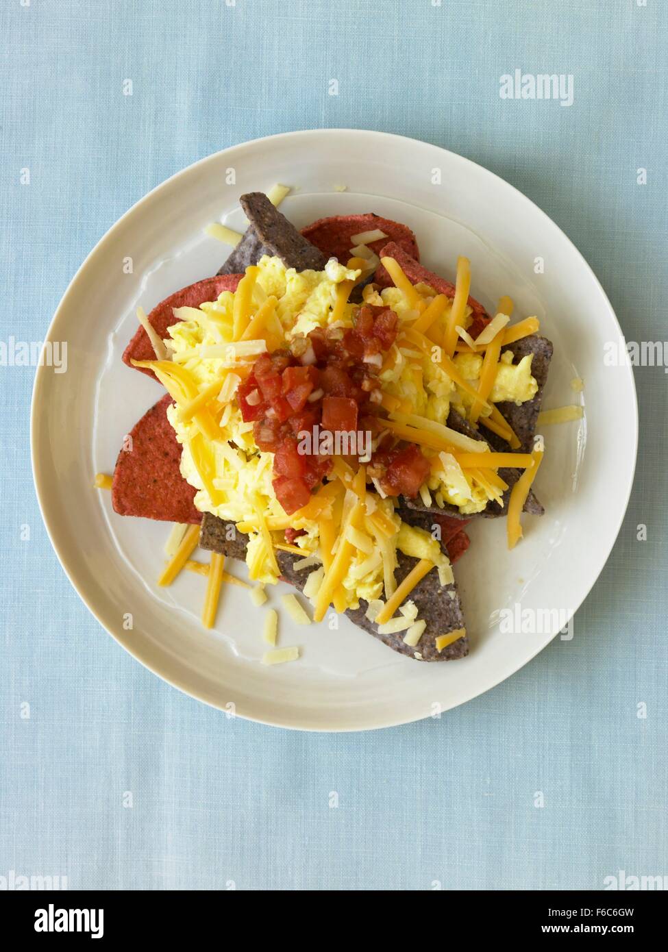 Tortilla Chips Topped with Scrambled Eggs and Salsa Stock Photo - Alamy