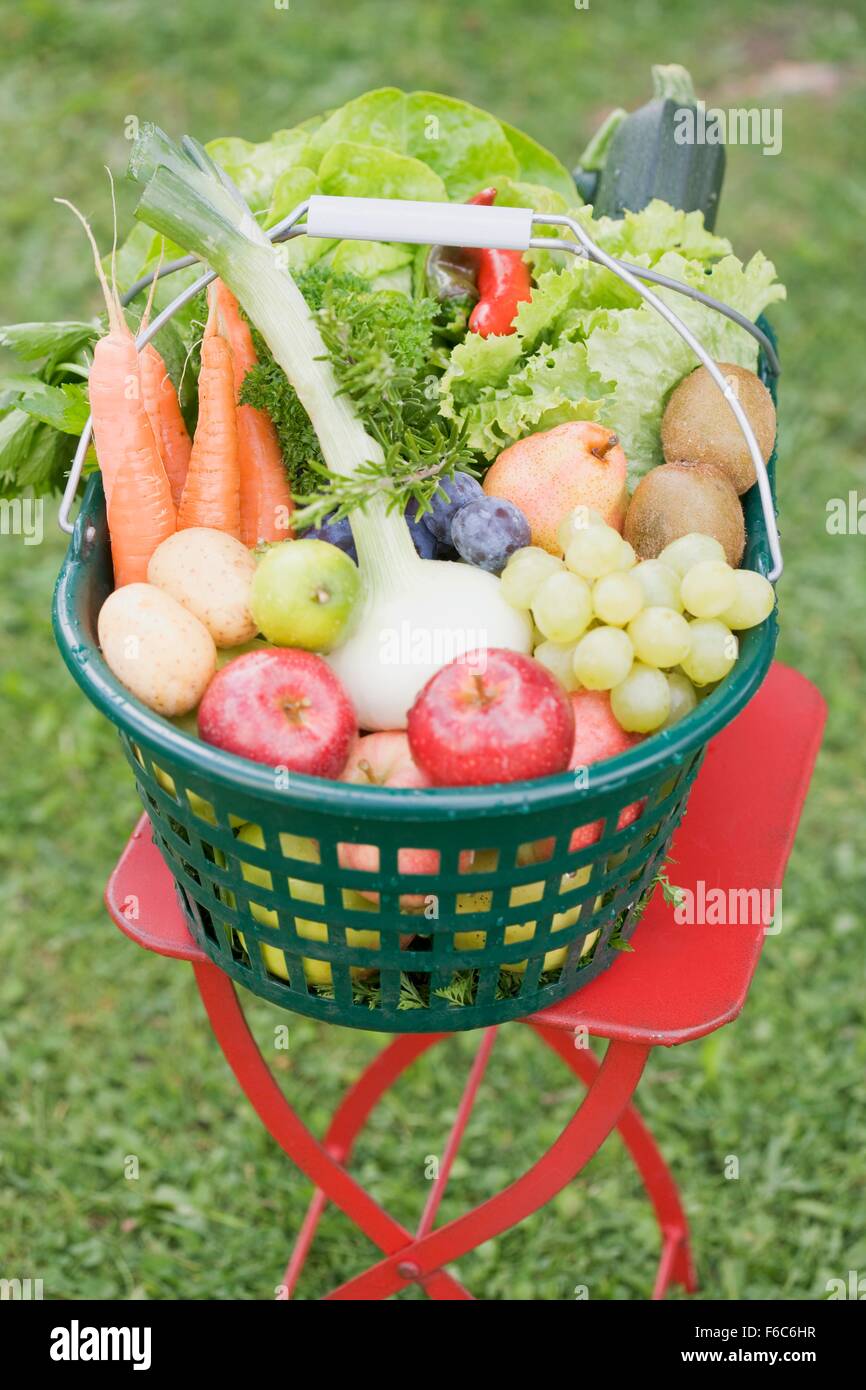 A basket of fresh fruit and vegetables on a garden table Stock Photo ...