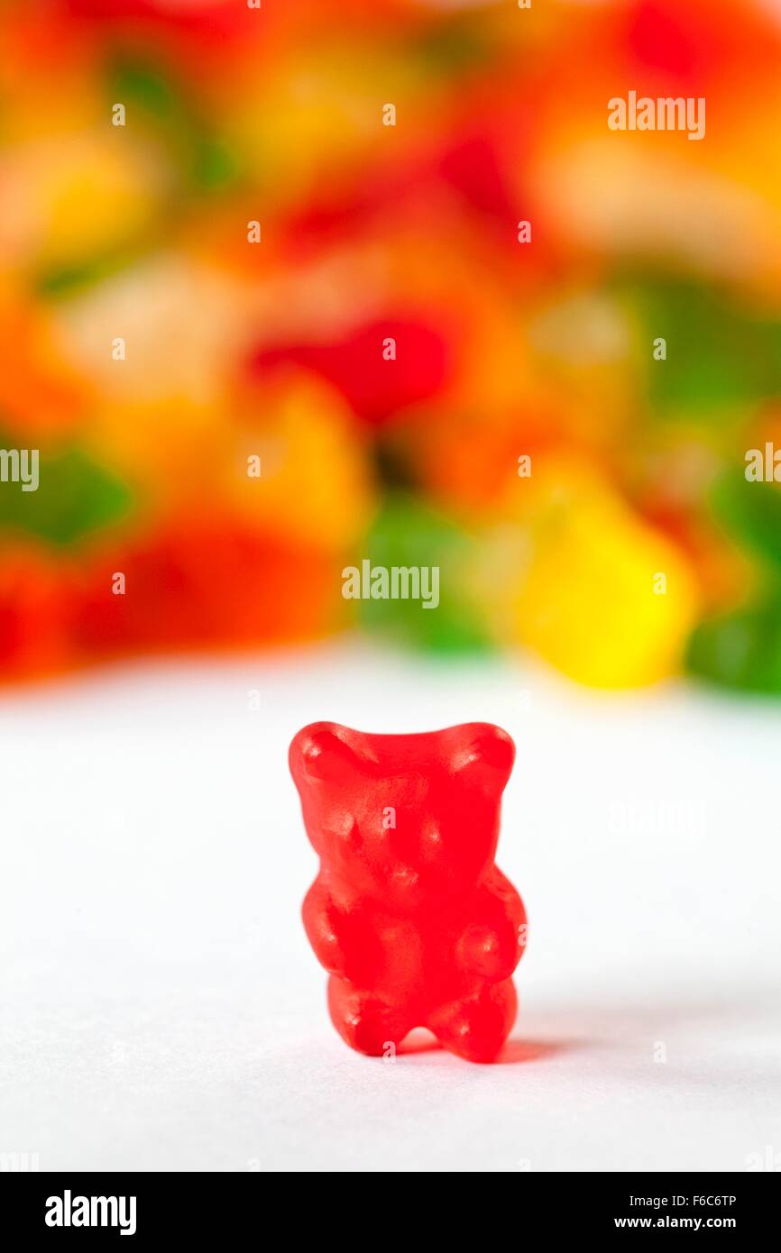 Red Gummie Bear; Many Gummie Bears in Background Stock Photo