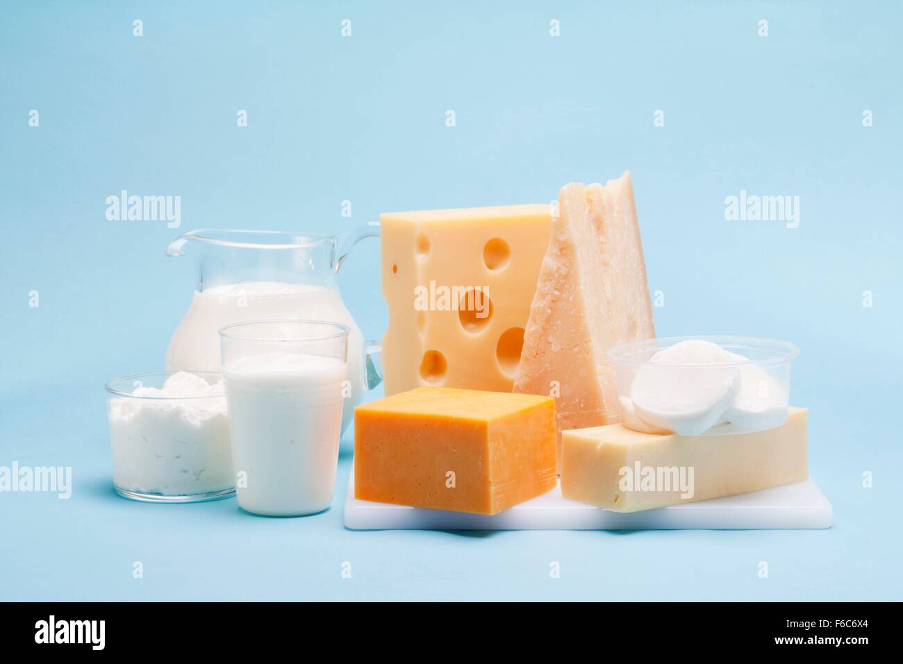 Various milk products (cheese, yoghurt, quark, milk) on a blue