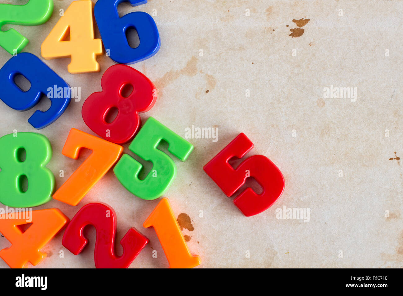 Border of colorful toy magnetic numbers with copy-space on old paper  background Stock Photo - Alamy