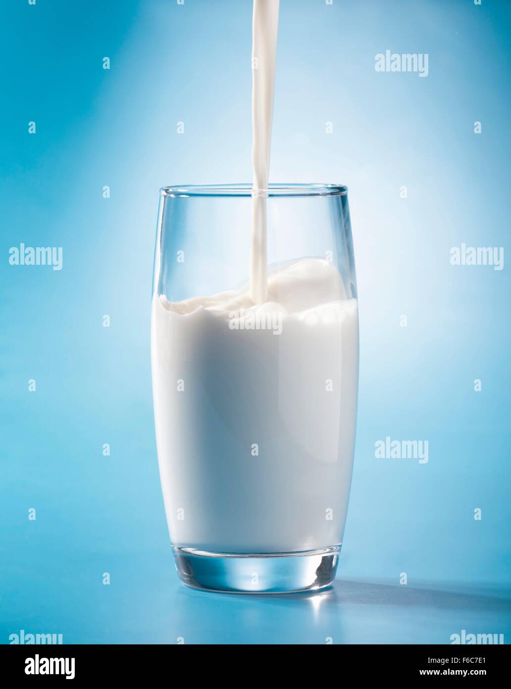 Pouring milk into a glass Stock Photo
