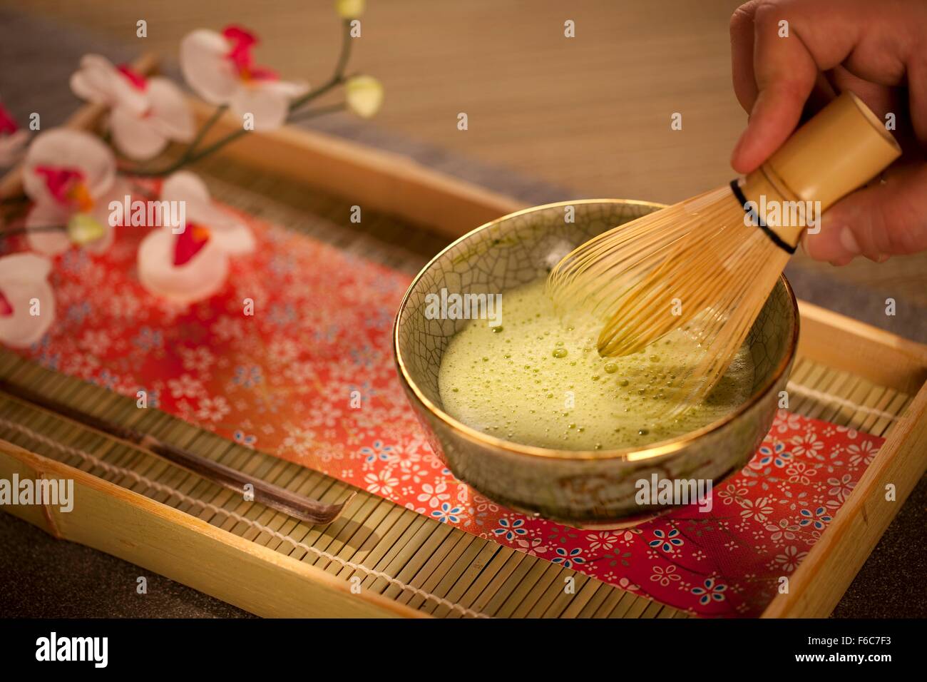 Mixing Japanese Matcha Green Tea in a Ceremonial Bowl with Whisk Stock Photo