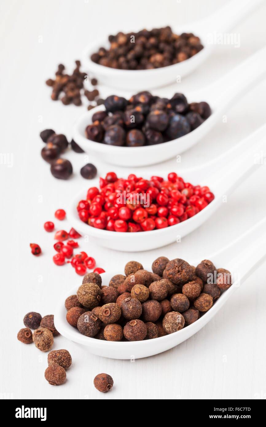 Allspice berries, pink pepper, juniper berries, black peppercorns on