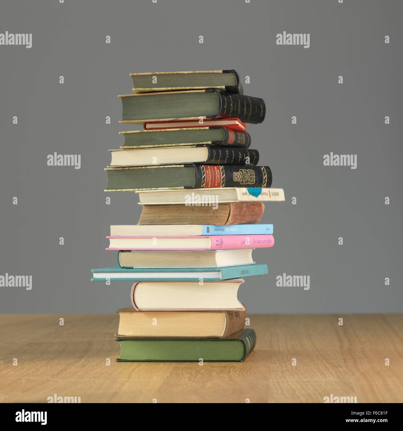A stack of books on a wooden table Stock Photo - Alamy