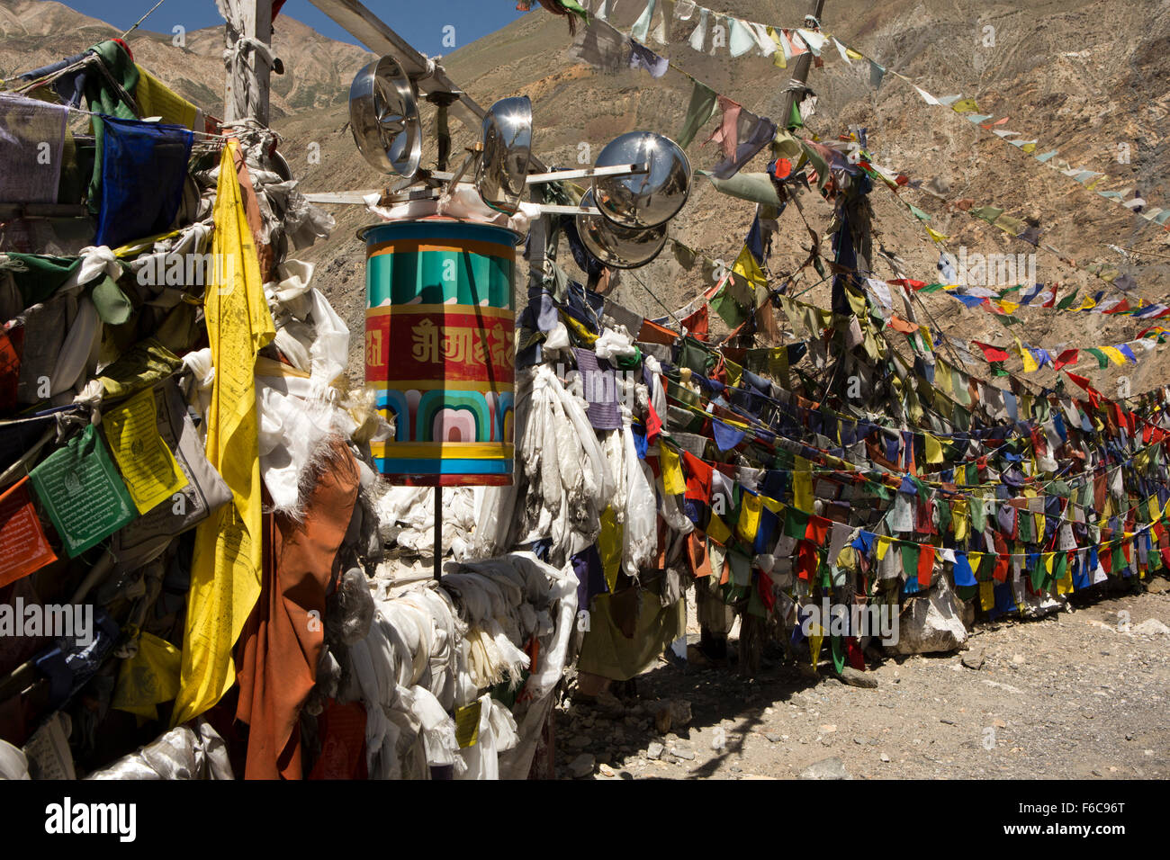 India, Himachal Pradesh, Kinnaur, Dirasang, prayer flags and wind powreed prayer wheel at roadside hermitage Stock Photo