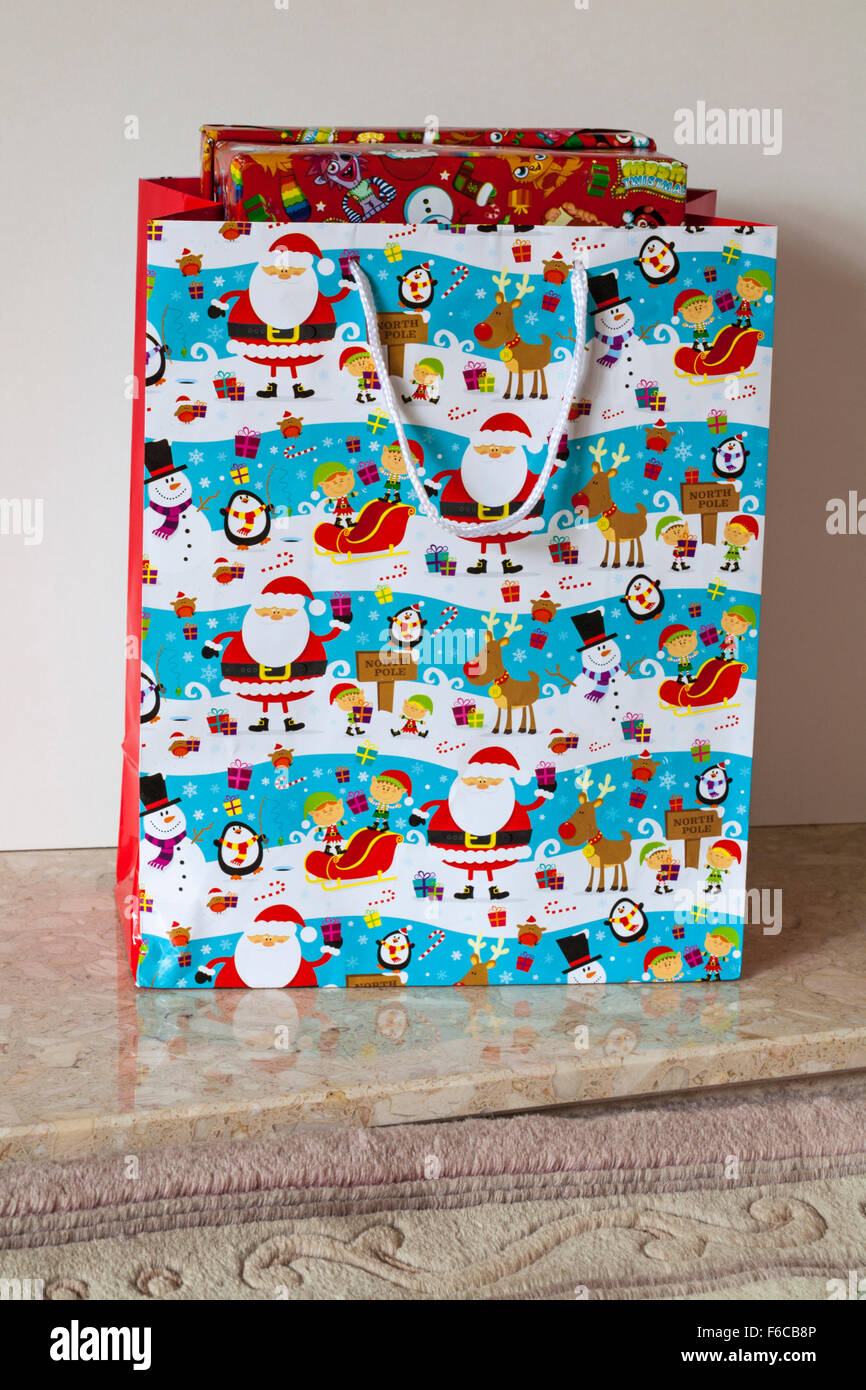 Christmas decorative gift bag with wrapped Christmas presents inside Stock Photo