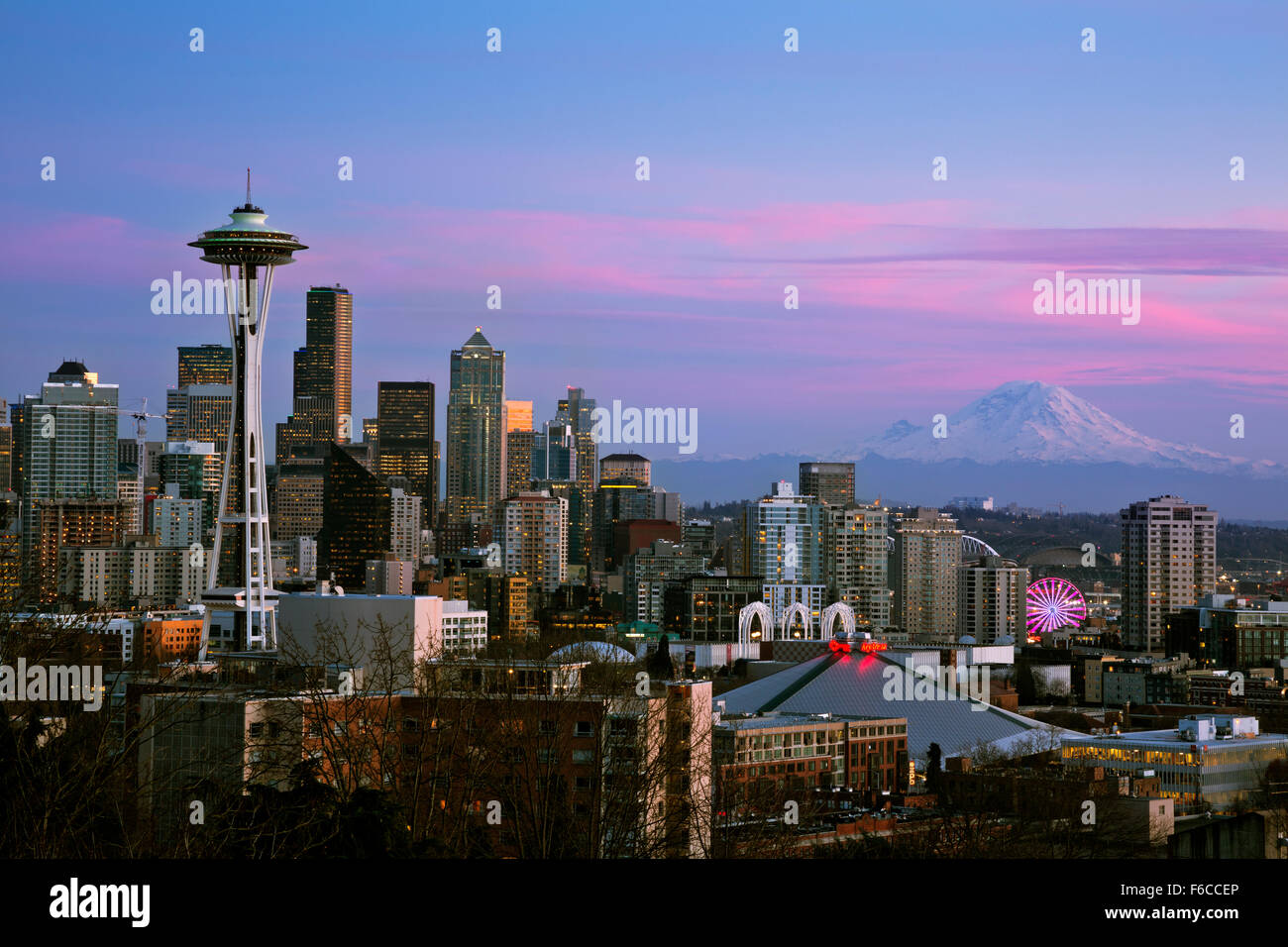 WA12045-00...WASHINGTON - Afterglow brightens the Space Needle, downtown Seattle and Mount Rainier. Stock Photo