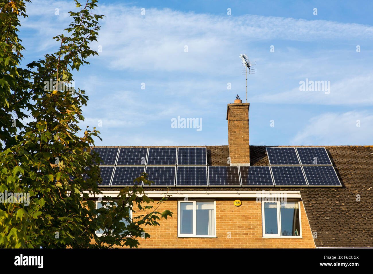 Solar panels and tiles on residential housing in the UK. Stock Photo