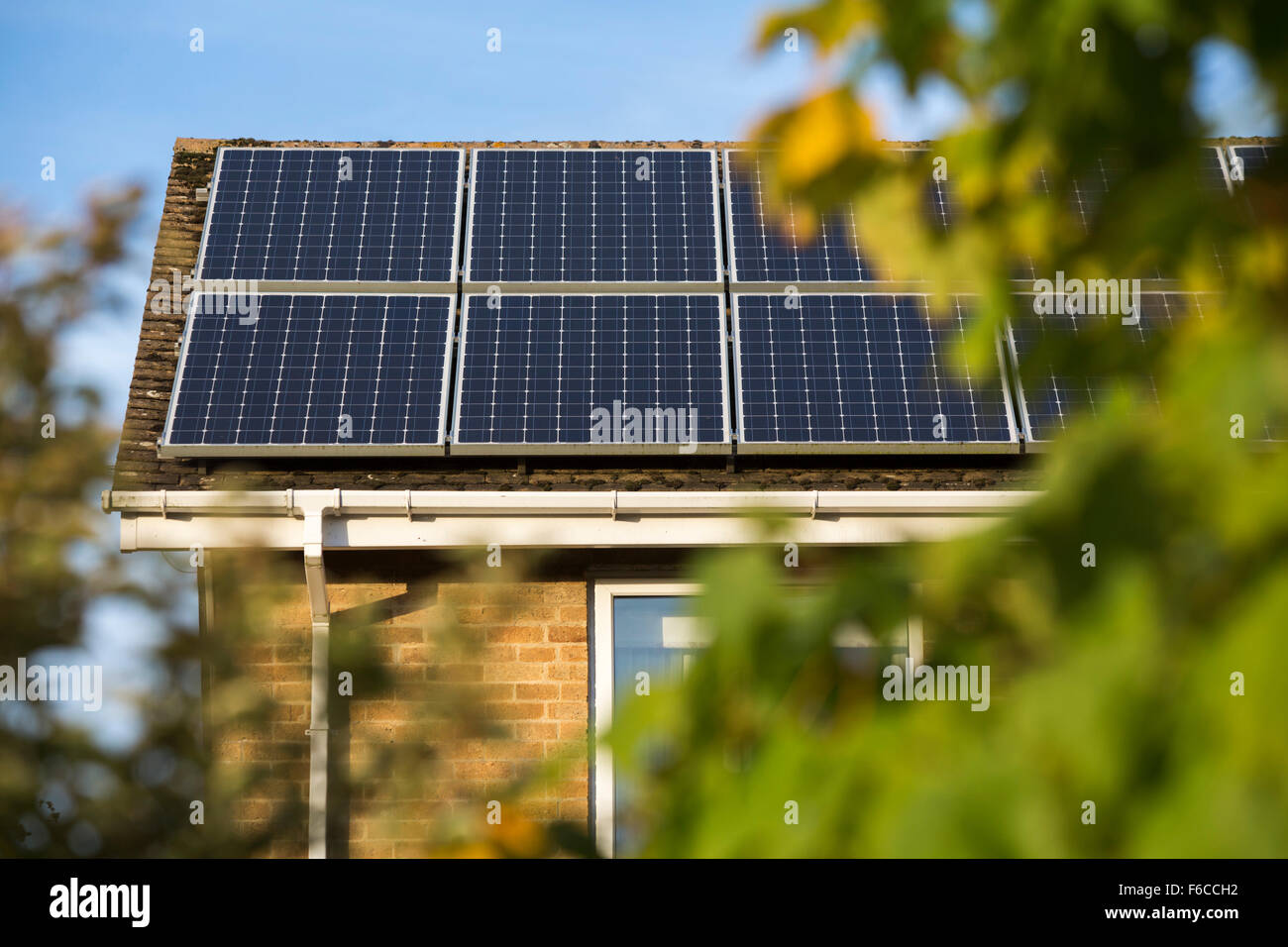 Solar panels and tiles on residential housing in the UK. Stock Photo