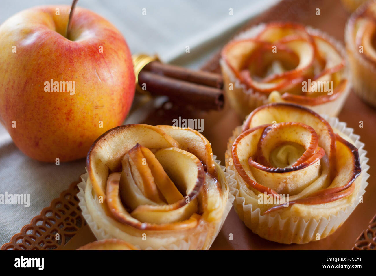 Rose shaped apple sweets flavored with cinnamon. Stock Photo