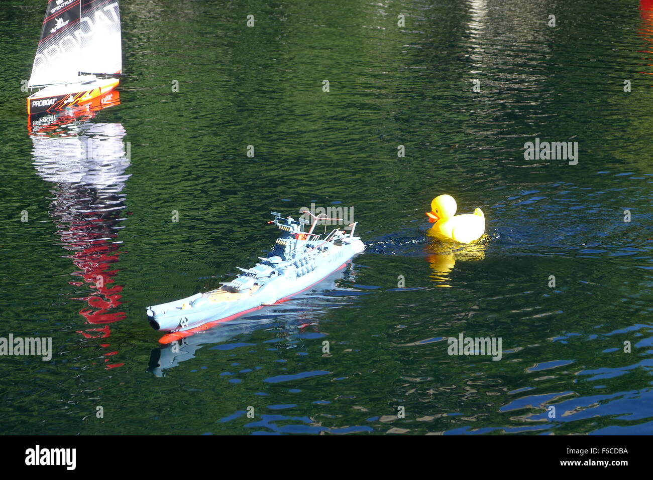 Toy Space Cruiser Argo and Rubber Yellow Duck on Conservatory Water in New York Central Park Stock Photo