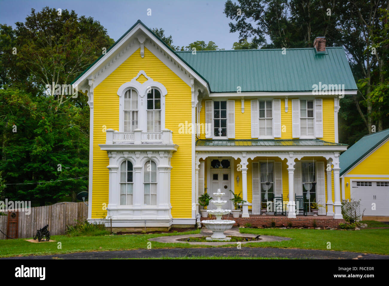 Historical Civil war era Colorful two storied Yellow Victorian house in Southern Gothic Style with porch in Bolivar, TN Stock Photo