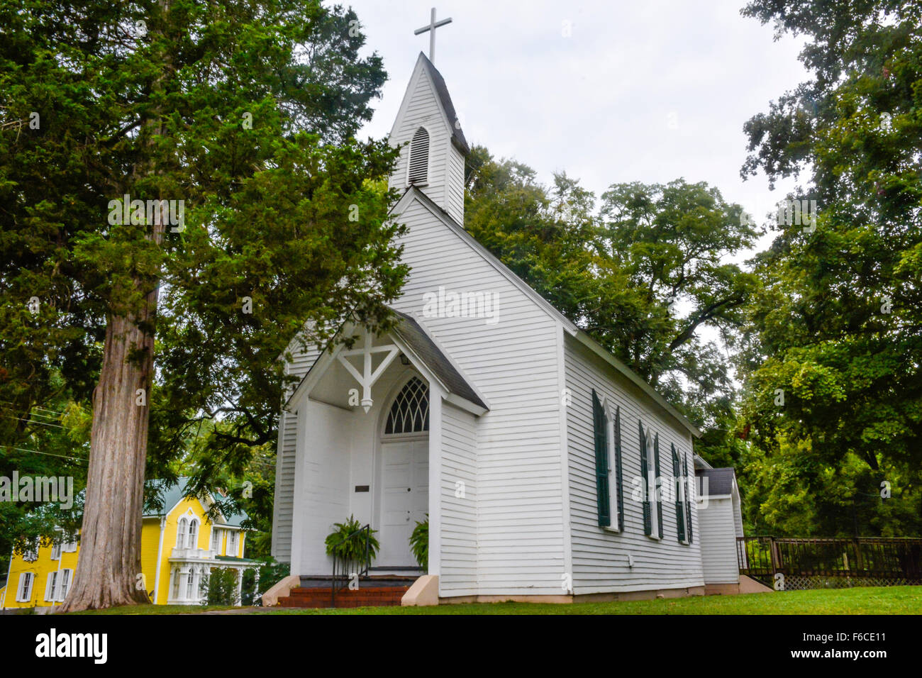 Small charming classic rural white clapboard church with steeple on property of St. James Episcopal Church in Bolivar TN Stock Photo