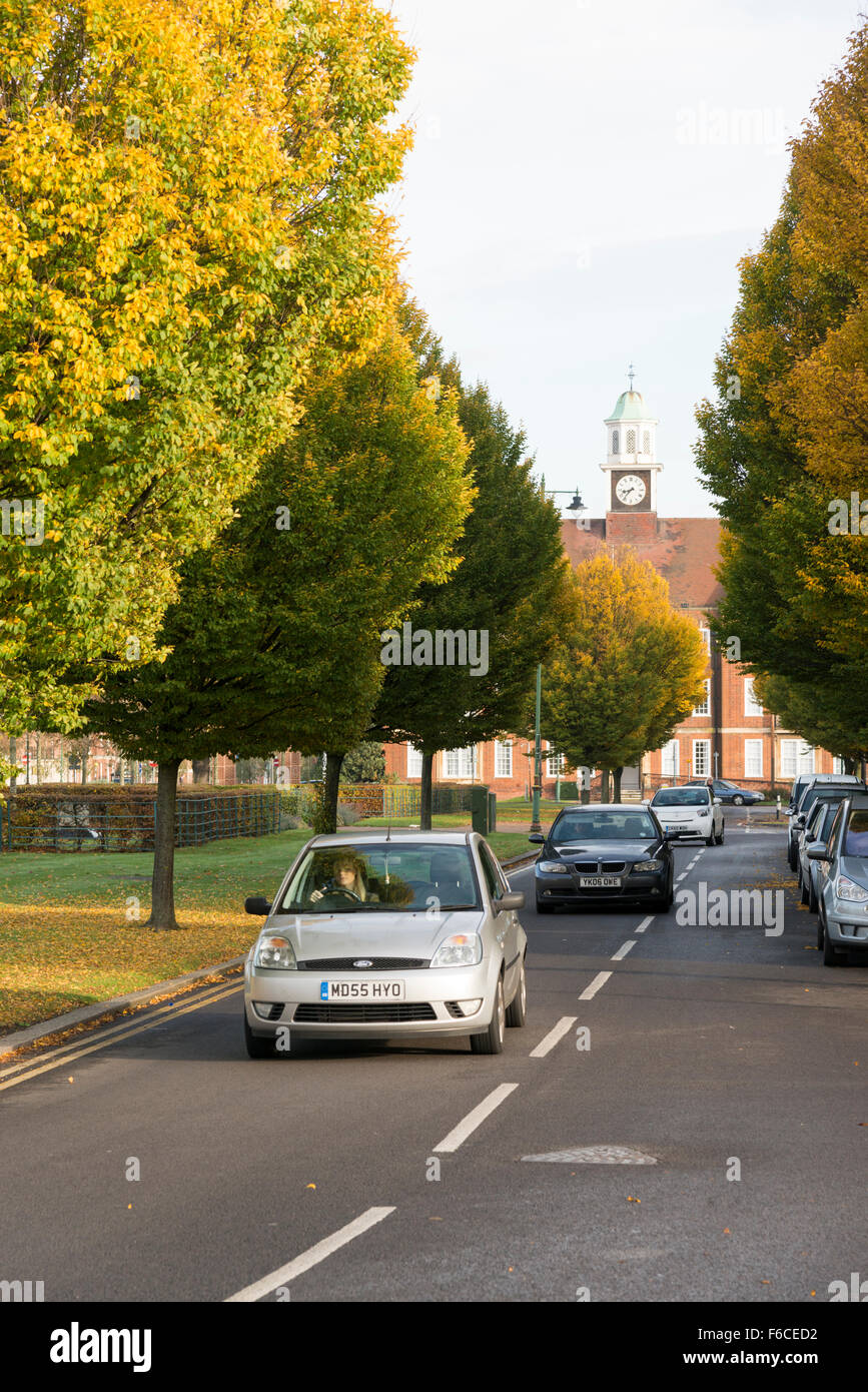 Cars driving on a tree lined road in Letchworth Garden City Hertfordshire UK Stock Photo