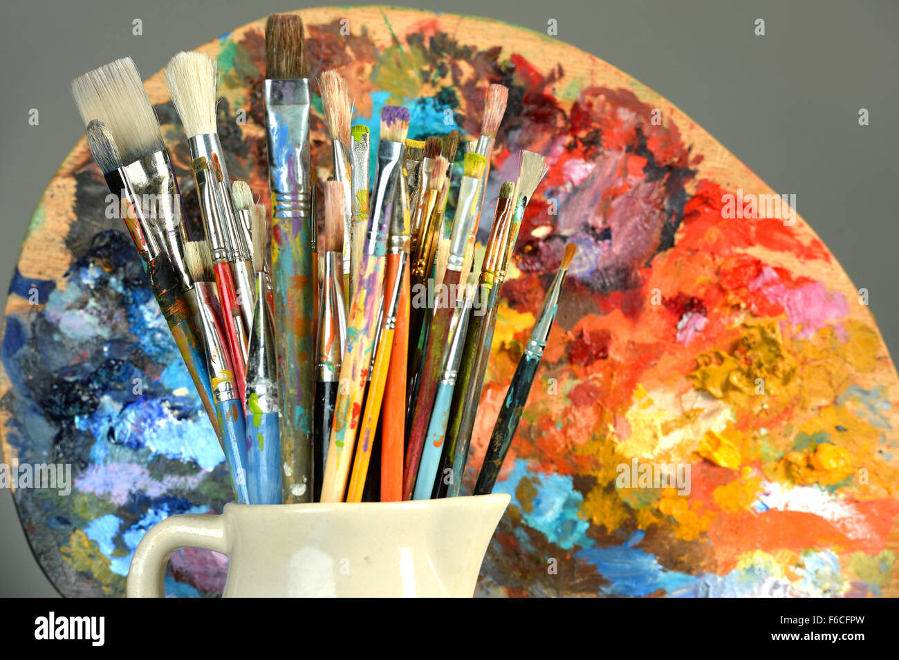 Paintbrushes and palette over gray background Stock Photo