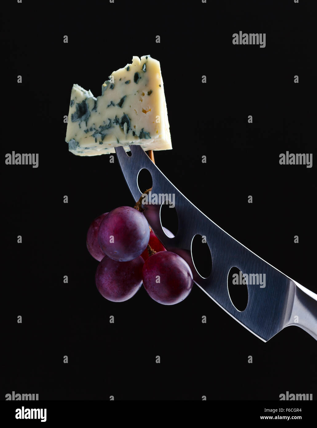 cheese and knife on a black background Stock Photo Alamy