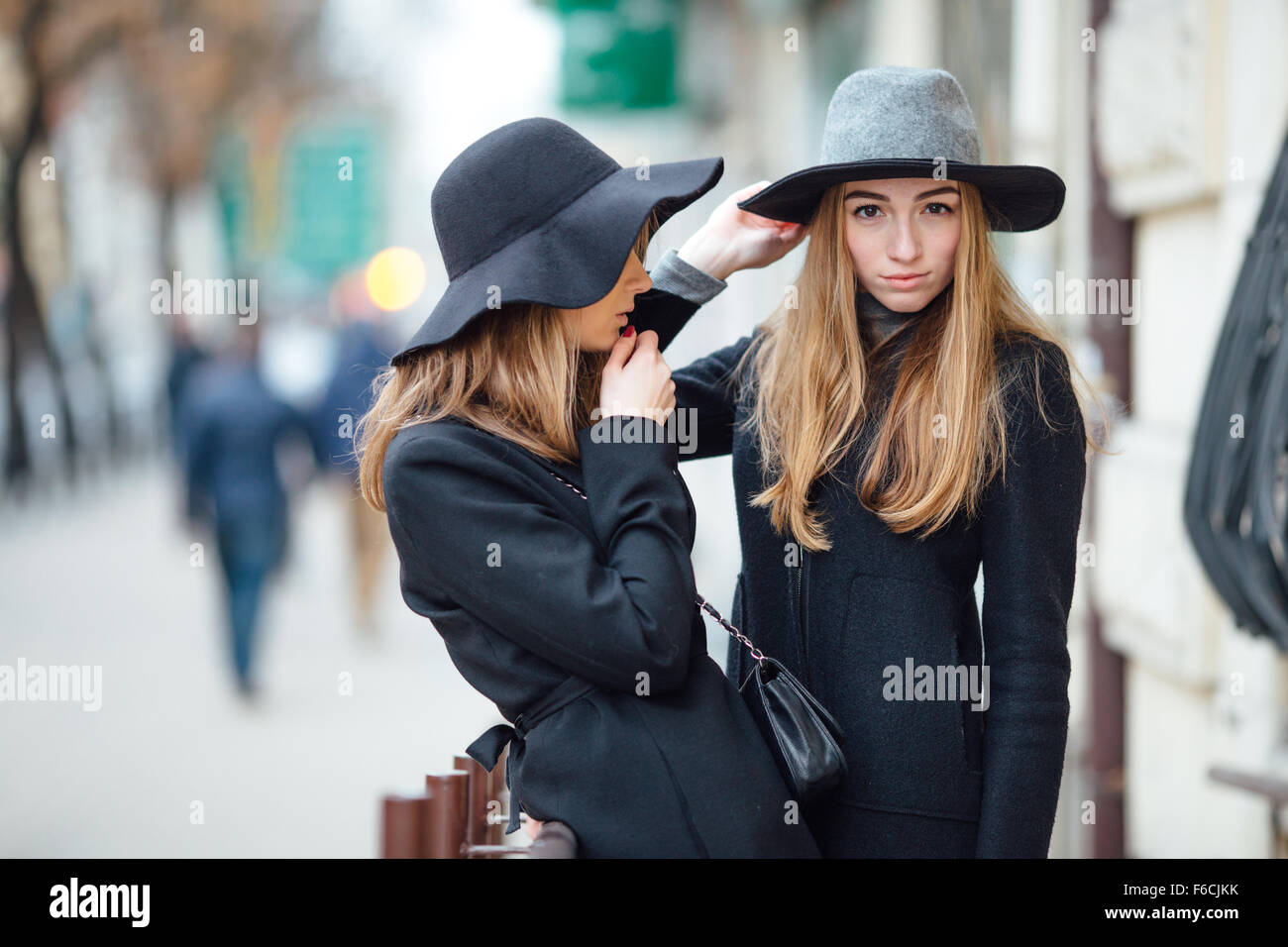 Two young girls walking on the street and posing to camera Stock Photo ...