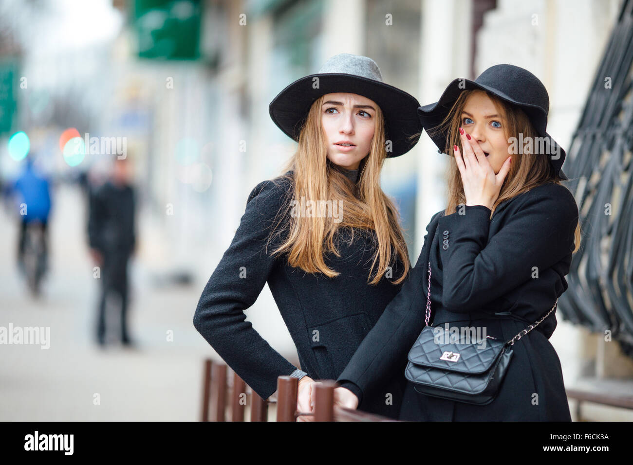 Two young girls walking on the street and posing to camera Stock Photo ...