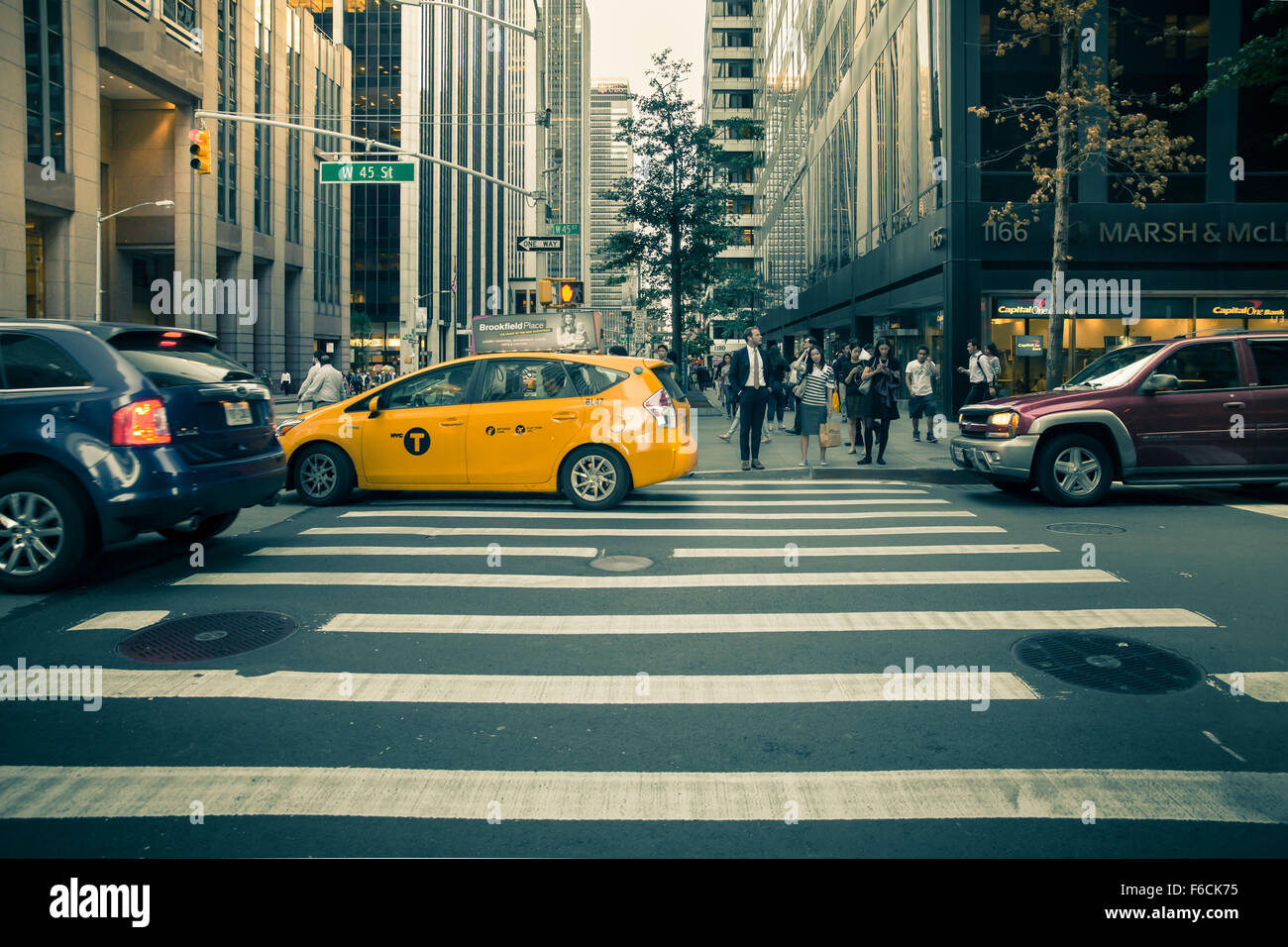 Pictured here is a street view in midtown Manhattan with cars, taxi and