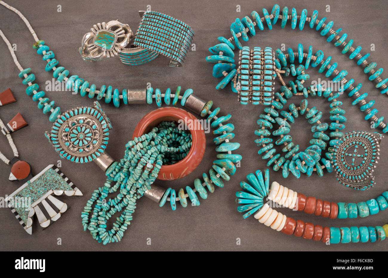 A collection of Vintage Zuni and Navajo Native American Jewelry made of turquoise, silver, pipe stone and Heishe beads. Stock Photo
