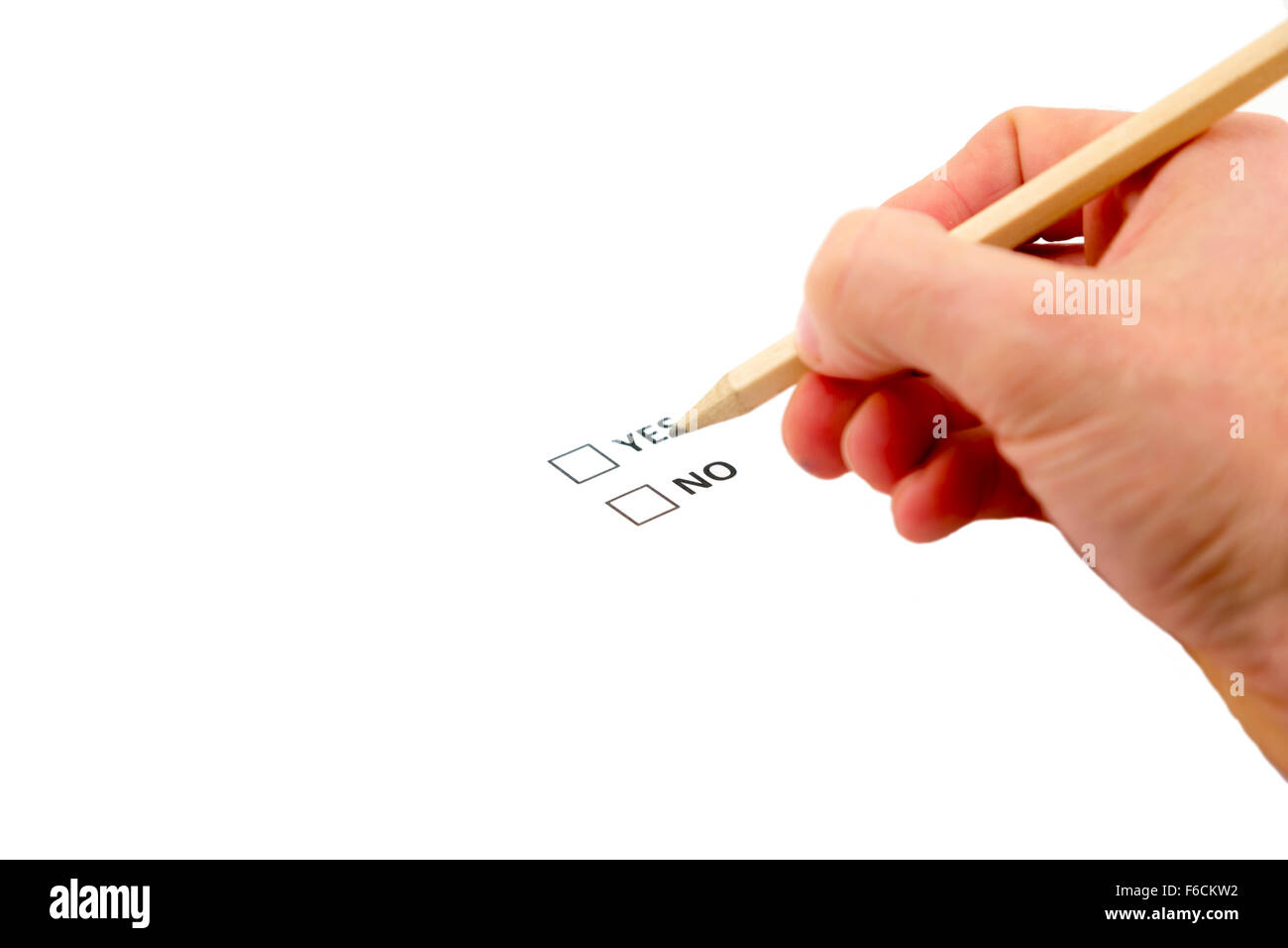 yes/no referendum vote ballot paper, with a person holding a pencil deciding which way to vote Stock Photo