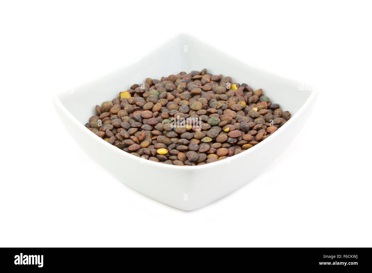 Green  Le Puy-en-Velay puy French lentils in a bowl against a white background Stock Photo