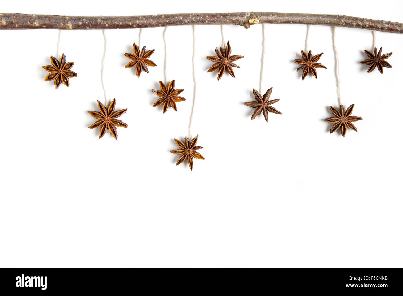 Christmas greeting card, hanging anise star on white background Stock Photo