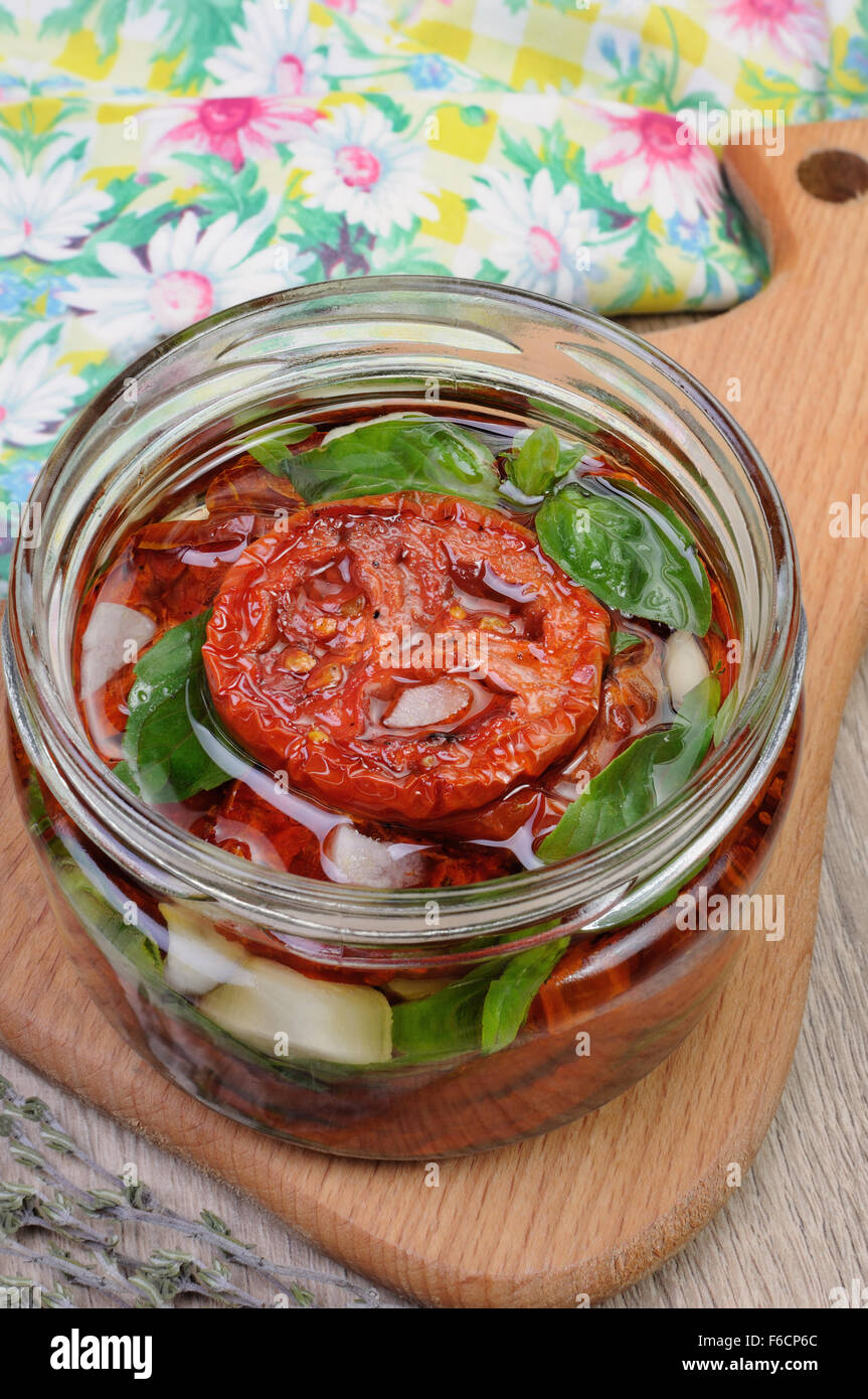 Slices of dried tomatoes with garlic and basil oil Stock Photo - Alamy