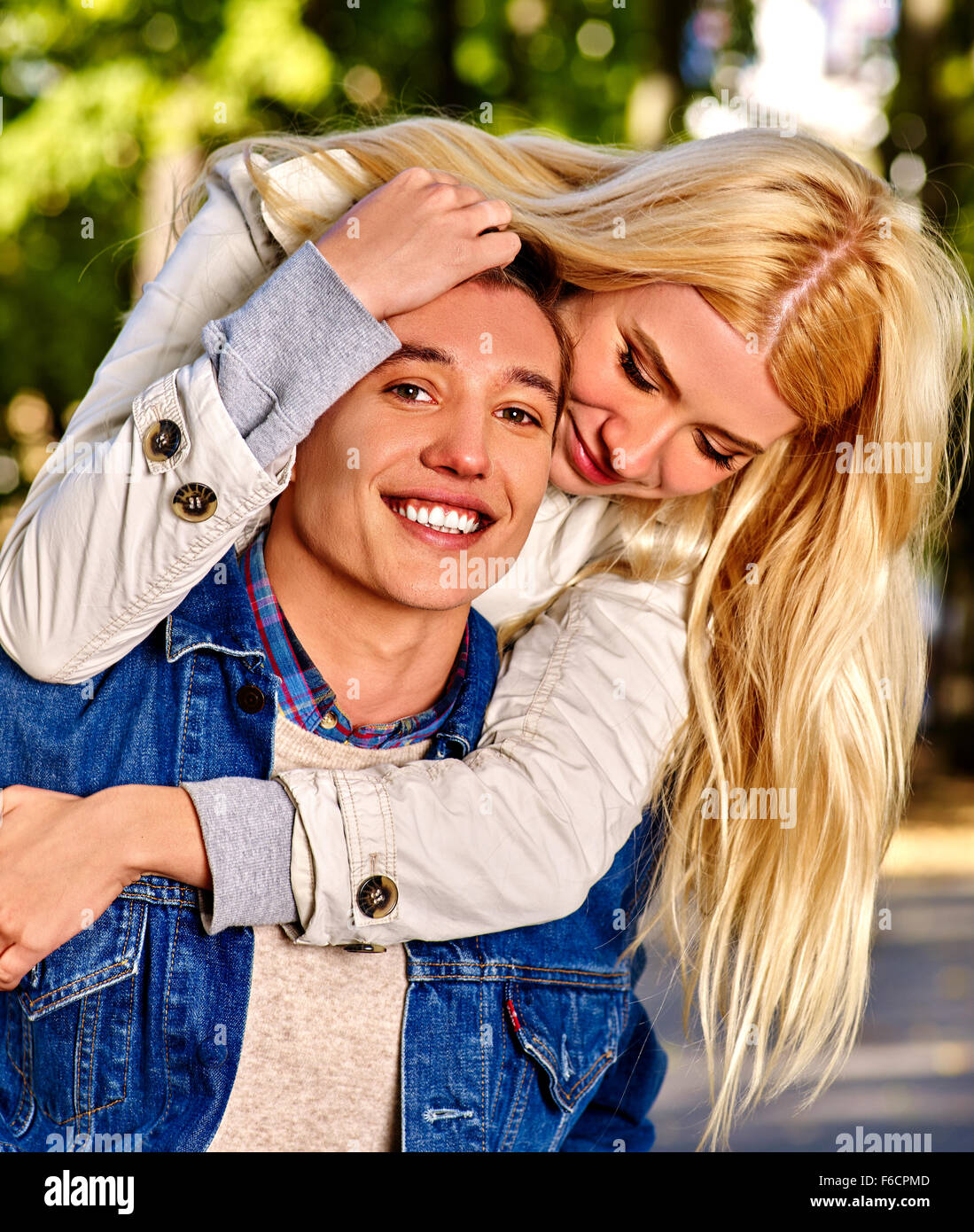 Young couple hugging and flirting in park Stock Photo - Alamy